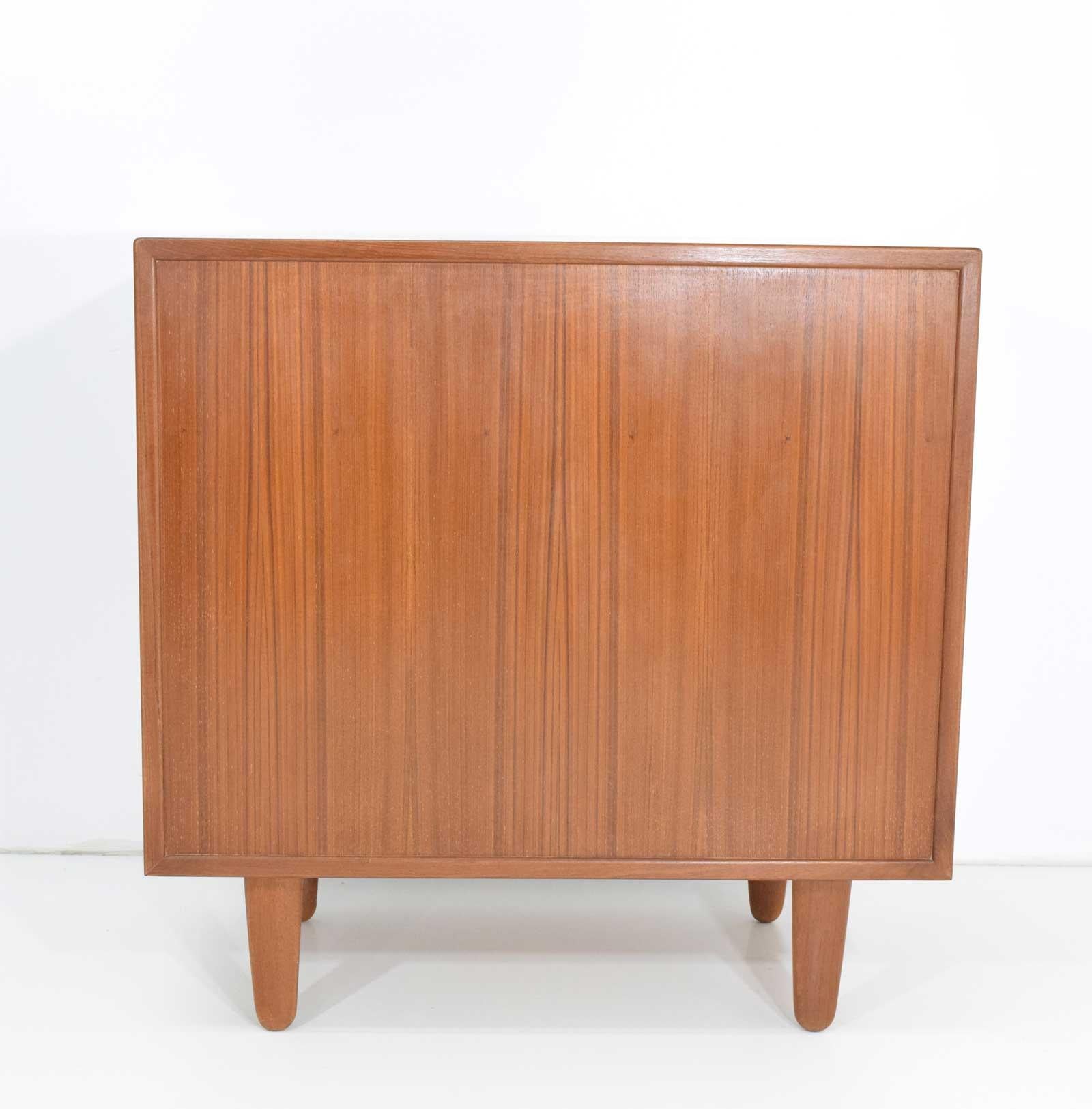 Beautiful chest of drawers from Denmark, dated 1960s. Chests has four drawers, large extended handles and a finished back.