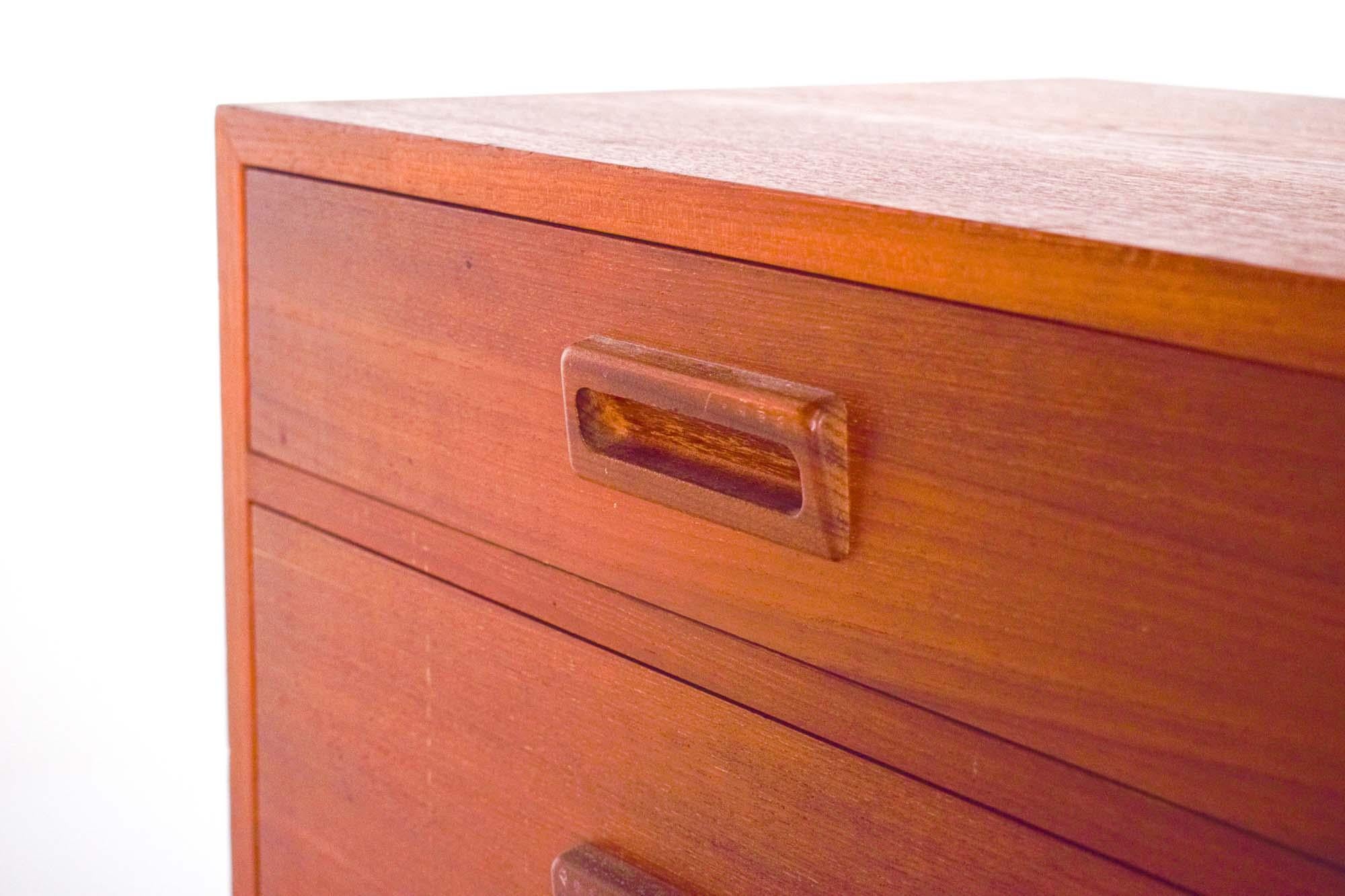 Nice vintage teak chest of drawers made of veneered original. Designed by Holger Jensen for FDB Mobler. Made in Denmark from the 1960s. Front with two small and two large drawers. Solid teak frame. In very well condition and refinished by us when it