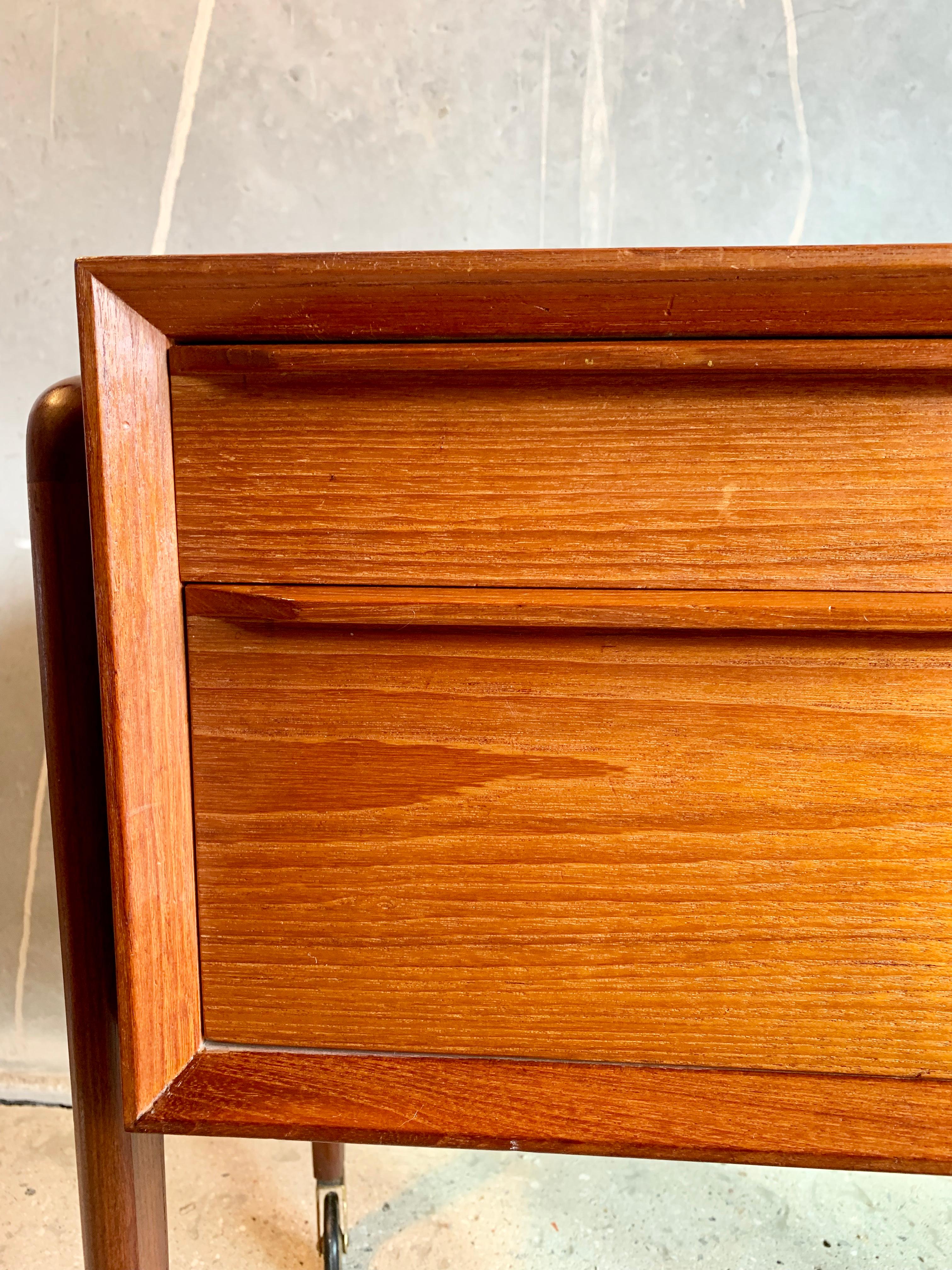 Chest made of teak, designed by Arne Vodder, featuring four drawers and wheels made of brass. Good Danish craftsmanship.