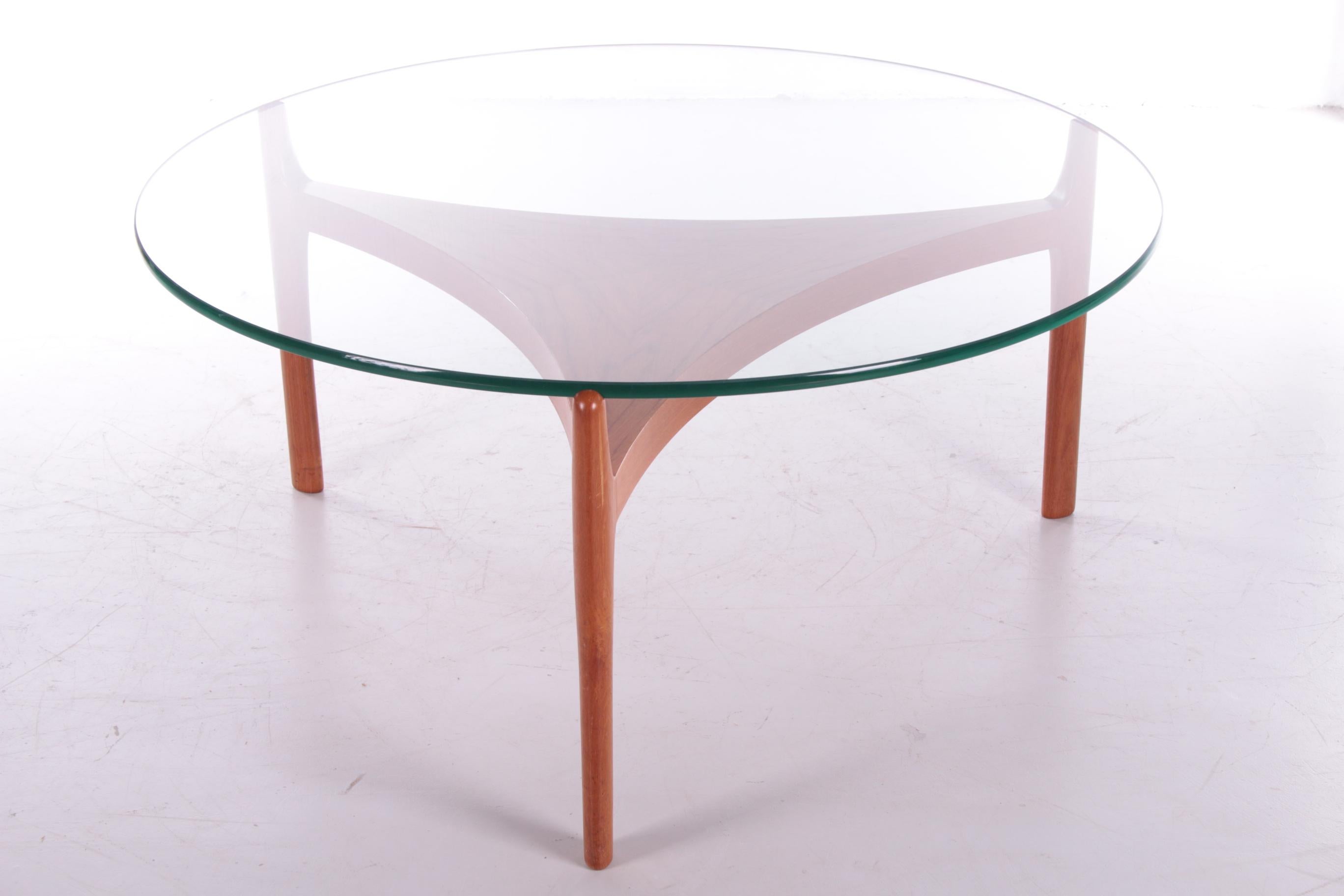 Beautiful teak coffee table designed by Sven Ellekaer 

from Christian Linneberg Mobelfabrik, Denmark in 1960.

The elegant base is made of curved teak with a thick glass top. 

The combination of the two materials gives the table a simple and