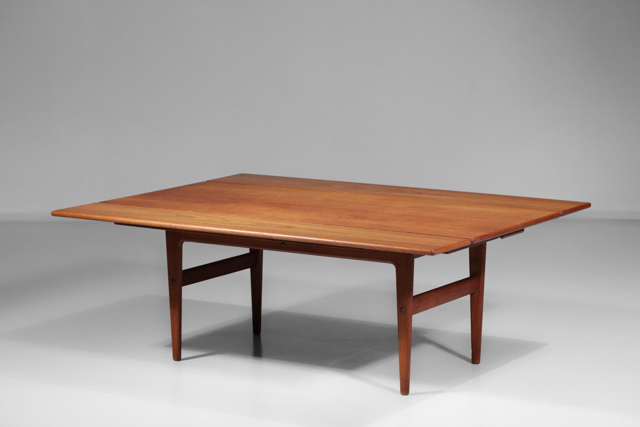 Danish coffee table from the 60's in solid teak, typical Scandinavian design. Very original and avant-garde composition for the time with a clever system of extensions and risers, possibility to transform this nice coffee table ( 52 cm high ) into a