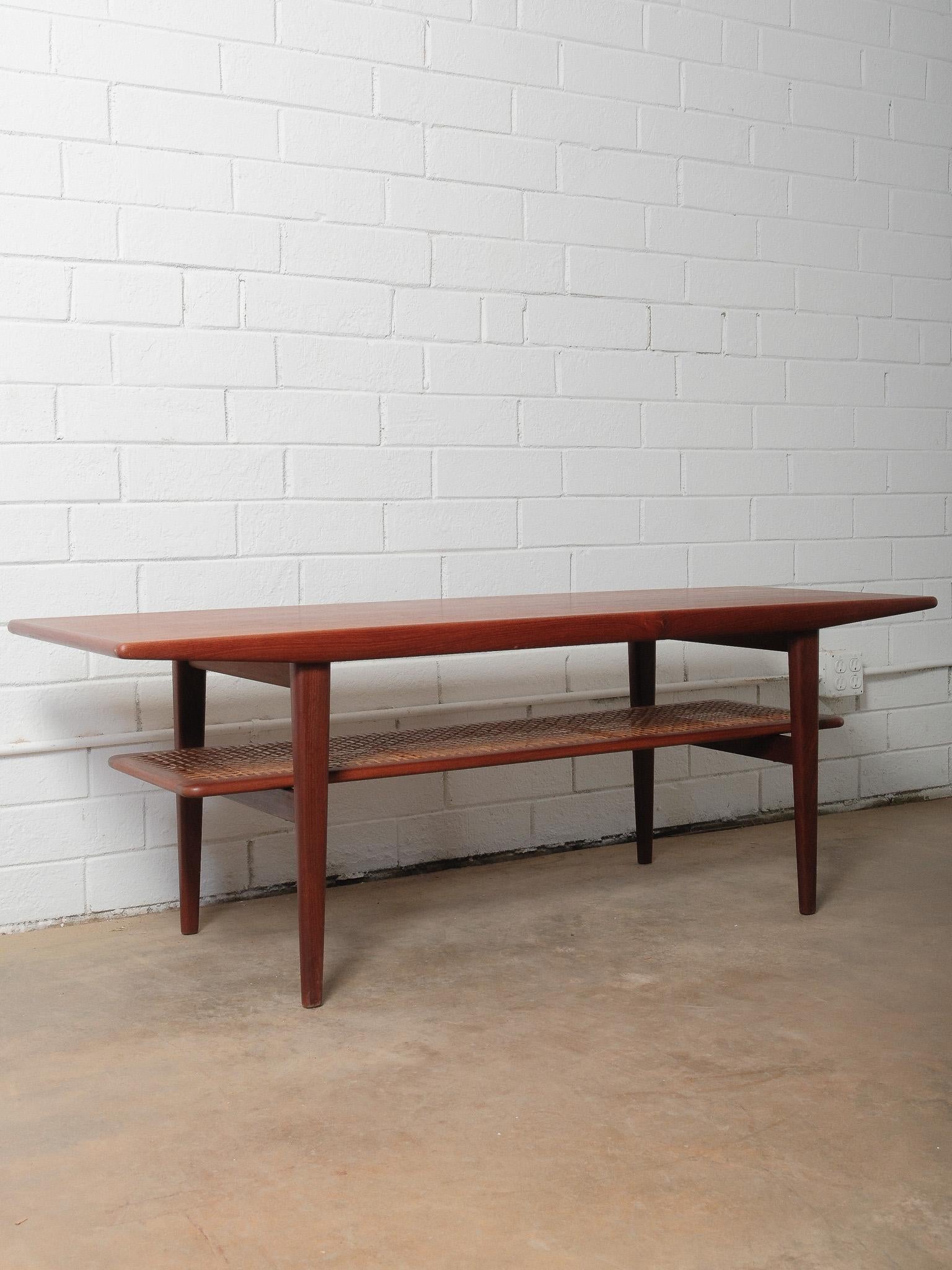 Mid-Century Modern Danish Teak Coffee Table with Cane Shelf by Niels Bach, 1960s For Sale