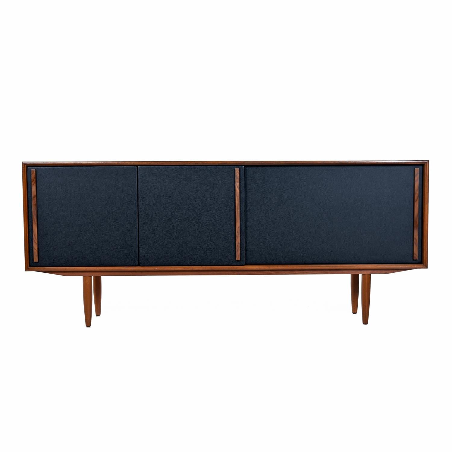 One-of-a-kind midcentury Scandinavian Modern Danish teak credenza by Gunni Oman for Axel Christensen Odder Mobler. 

What makes this one of a kind? Well, the original sliding doors had severely damaged pulls, so our rehabilitation team