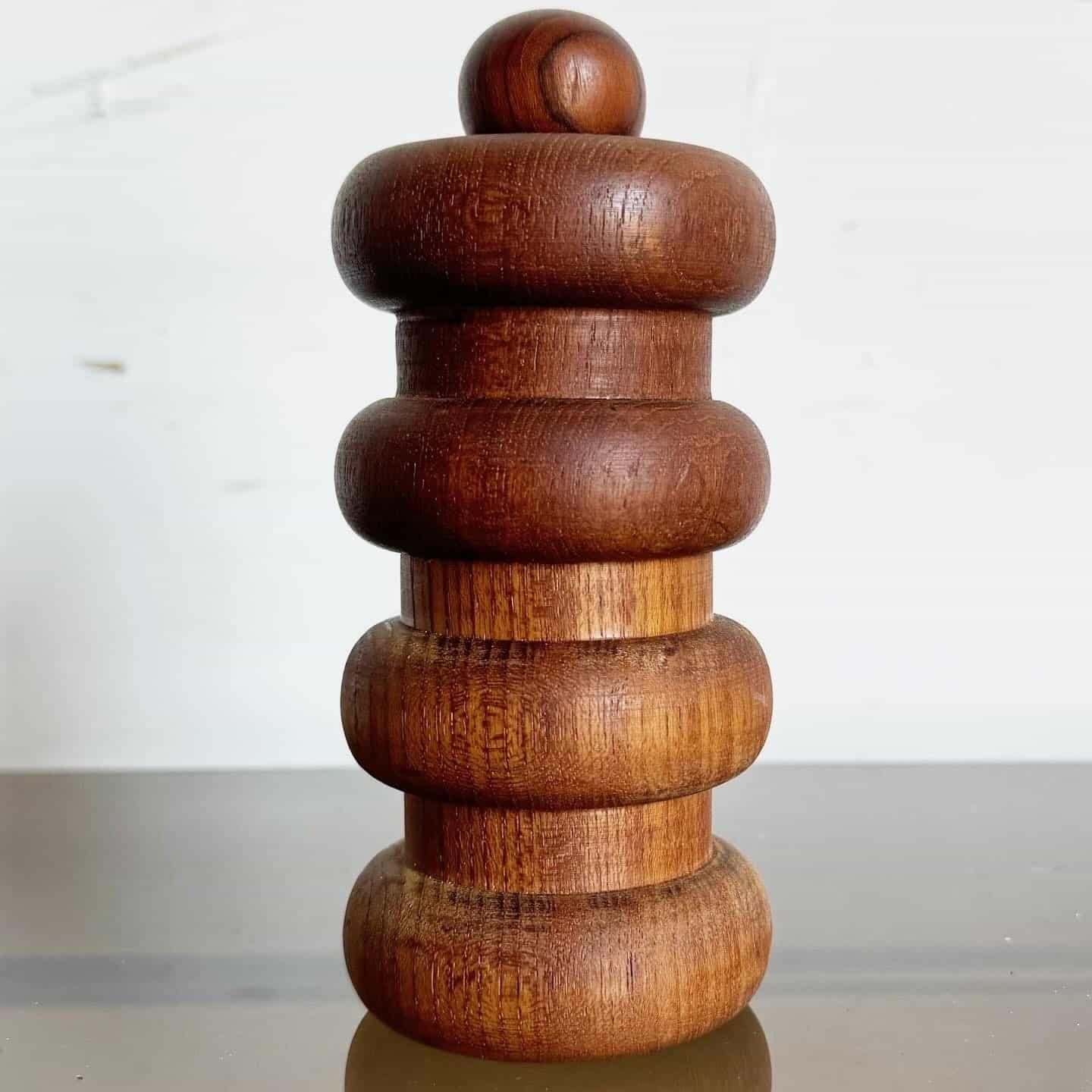 Dansk Designs Pepper Grinder/Salt Shaker by Jens Quistgaard. This dual-purpose piece marries rich teak wood with a minimalist design, featuring a pepper grinder on one end and a salt shaker on the other. Perfect for mid-century design lovers or