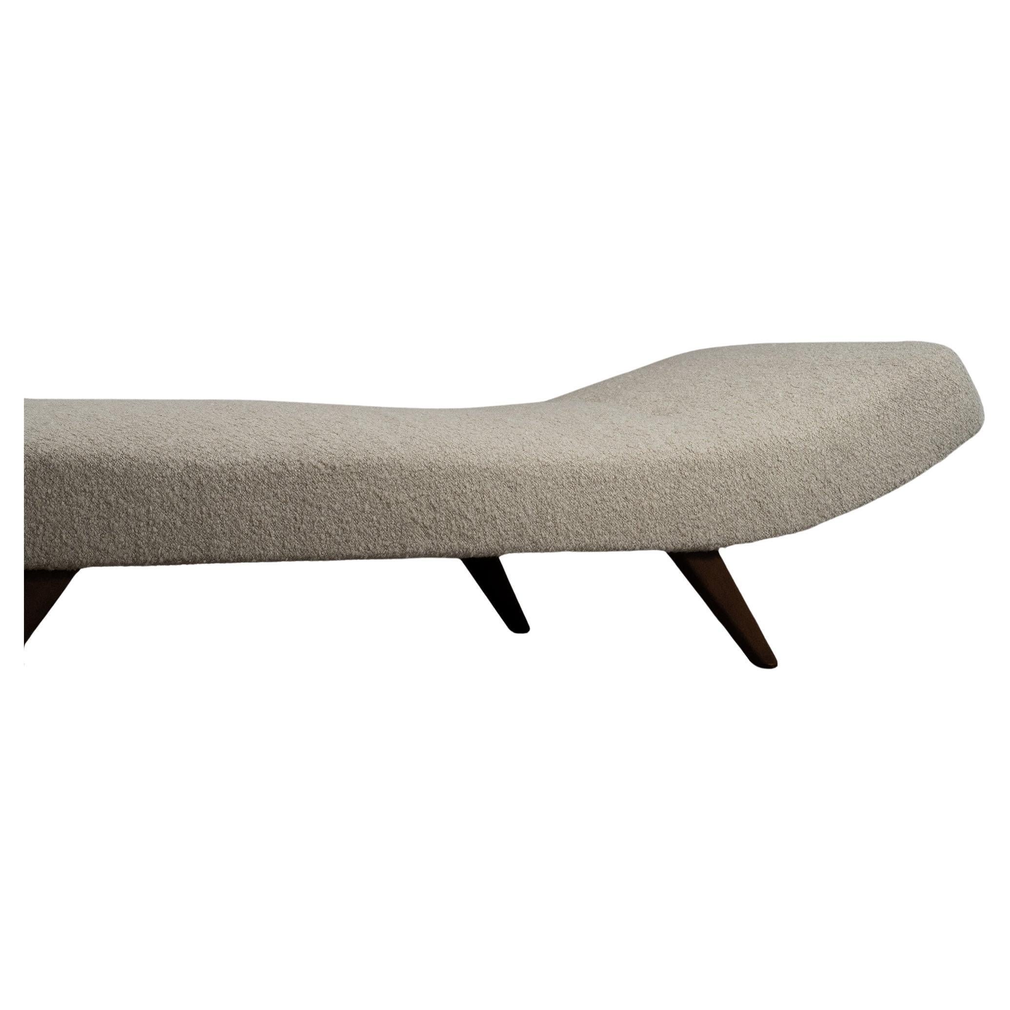 Modern minimalistic and sleek daybed, inspired by classic Danish furniture design. The daybed features a single long mattress with button tufting to provide more depth. The dark wooden legs have been newly oiled and the mattress has been