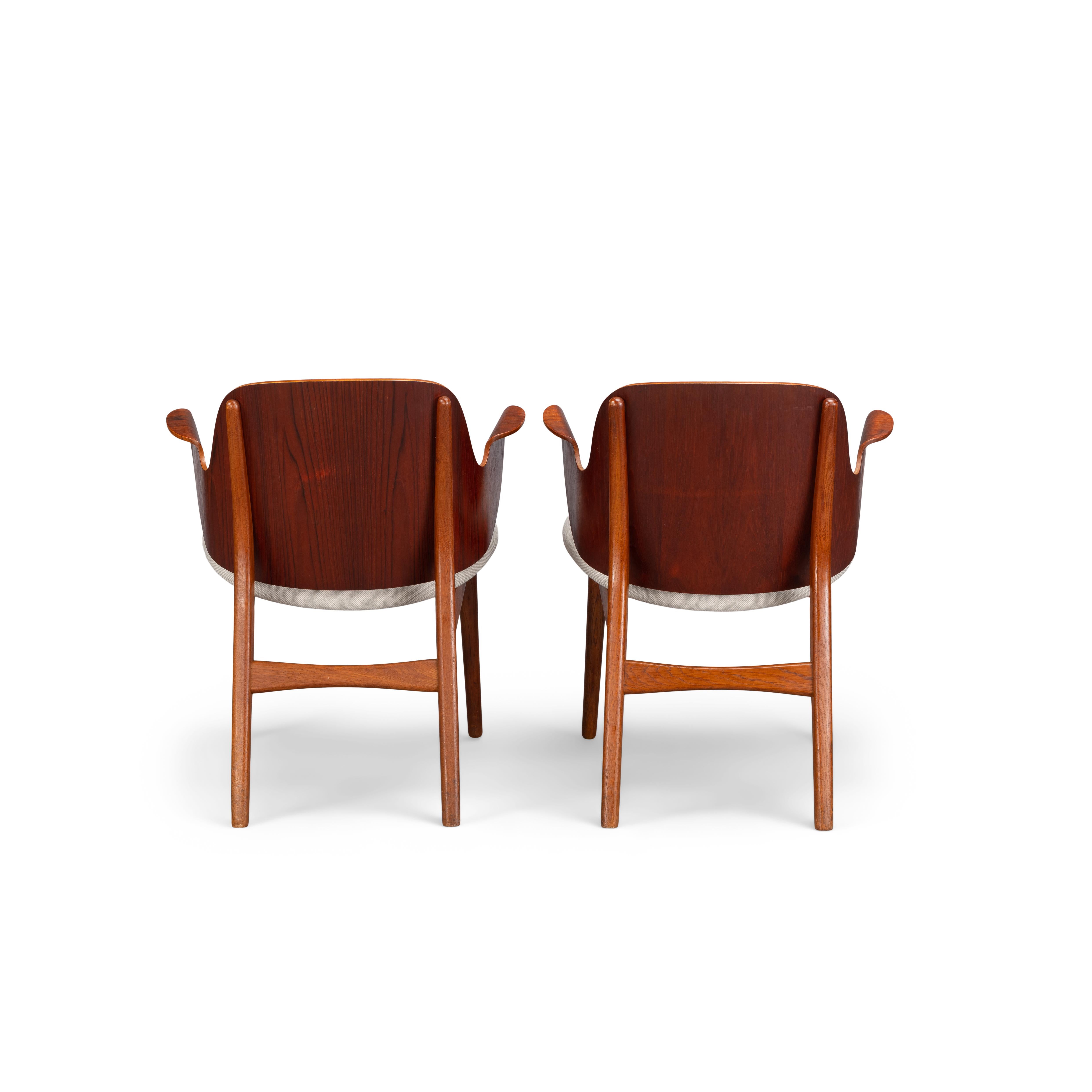 This pair of armchairs was designed by Arne Hovmand Olsen in the 1960s. These rare chairs are produced by high end cabinetmaker Bramin Møbler and are made of solid teak, plywood en reupholstered with Ploegwool Kl. 91. The armchairs are only sold as