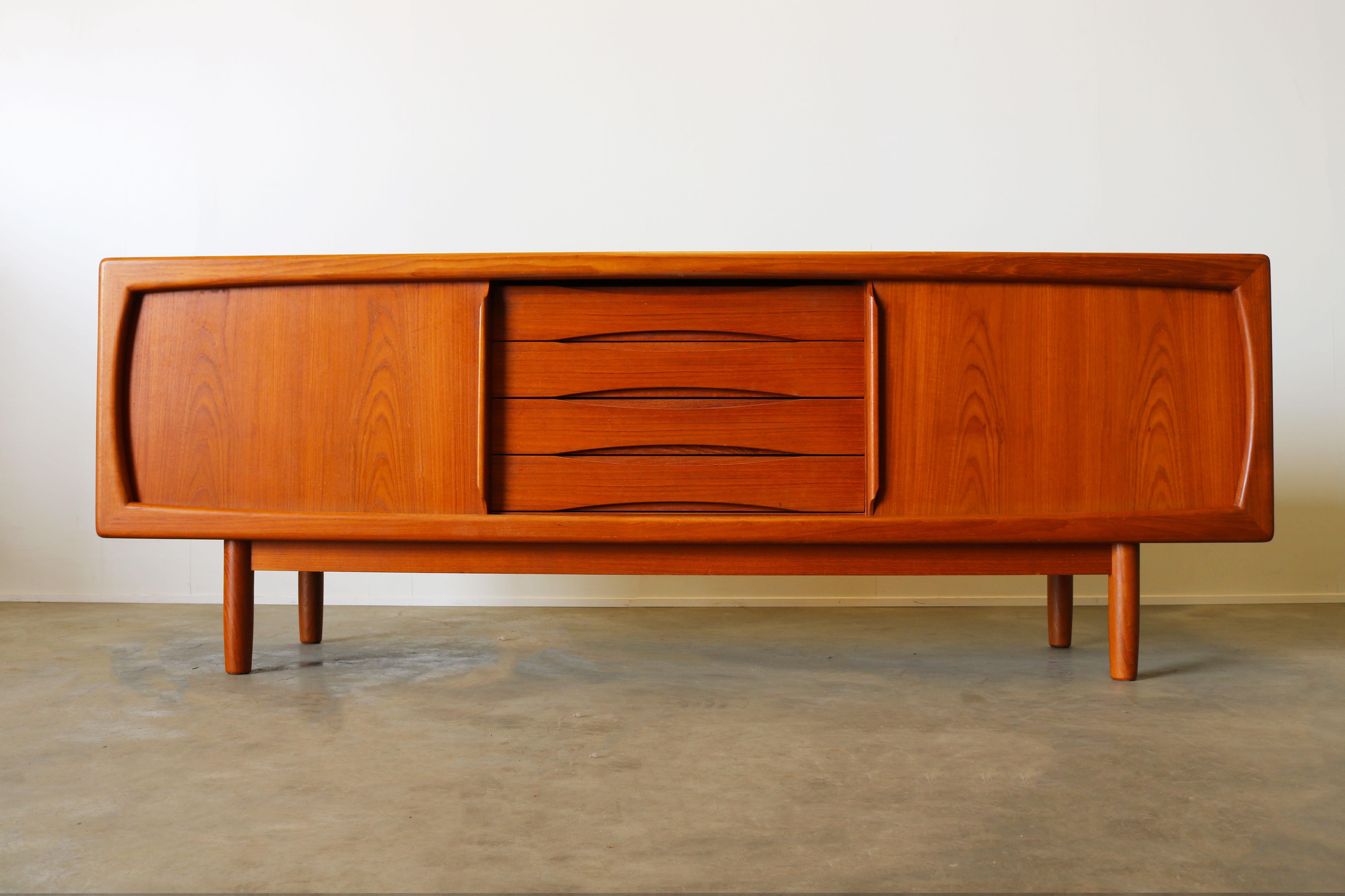 Magnificent Danish design sideboard or credenza designed by H.P. Hansen in the 1950s. The sideboard is made from solid teak and has four uniquely shaped drawers and two sliding doors. The sideboard is of high quality and in nice vintage condition.