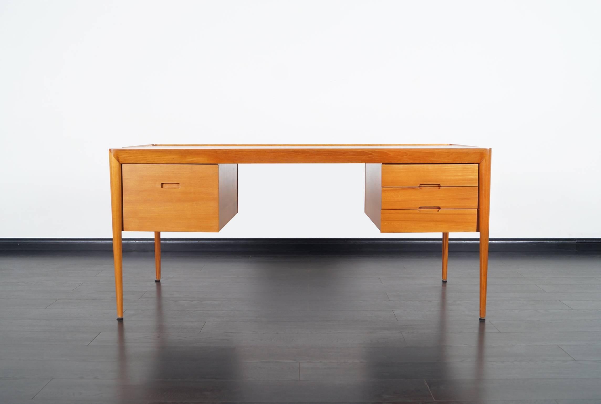 Stunning rare danish teak desk designed by Erik Riisager Hansen for Haslev Mobelsnedkeri in Denmark.