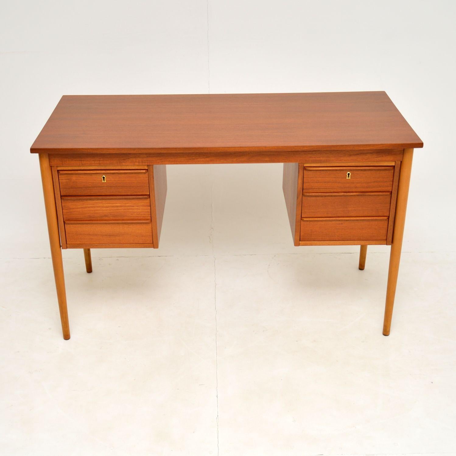 A stylish and practical vintage desk in teak, this was made in Denmark and dates from the 1960’s.

It is very well made, with a beautiful and minimal design. There is a locking key that comes with this for the two top drawers. This is also nicely