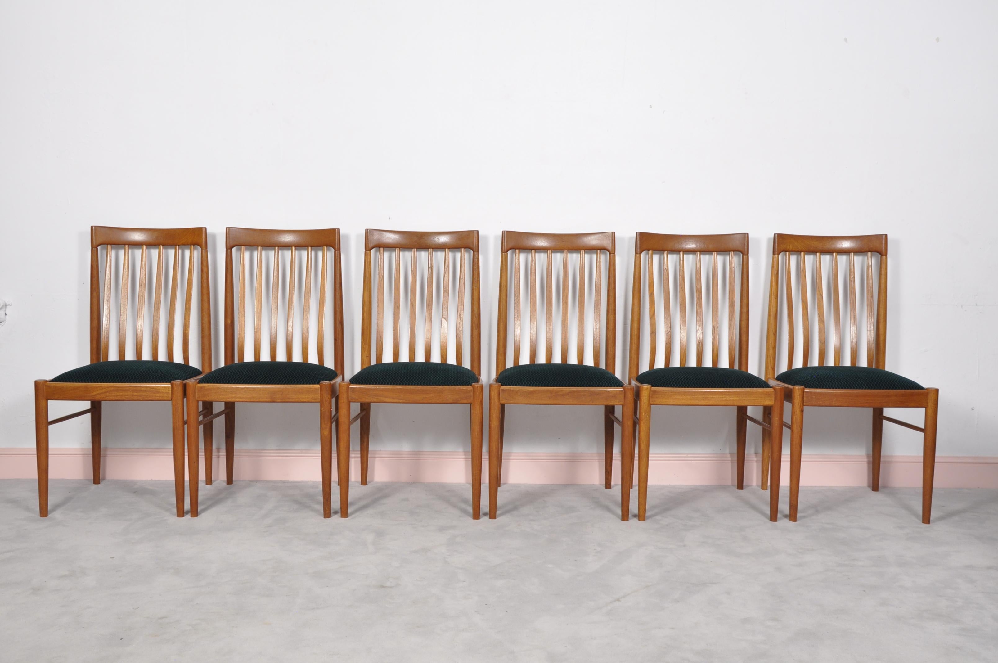 A superb set of six Danish dining chairs, in solid Teak, made by Bramin and designed by H. Klein. They date from circa 1960s-1970s, and the condition is excellent for their age. The drop in seats have been newly re-upholstered in green velvet fabric.