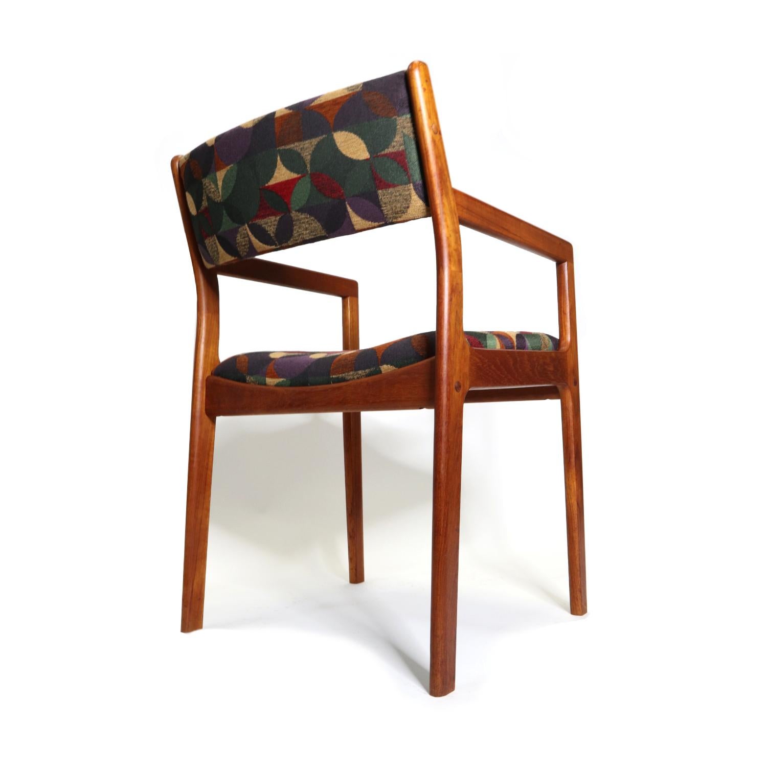 Set of six Danish teak dining chairs recently reupholstered in Knoll fabric. This set of six includes two arm chairs and four armless side chairs. The previous owner opted for luxurious Knoll textile in a novel multi-color pattern. The upholstery