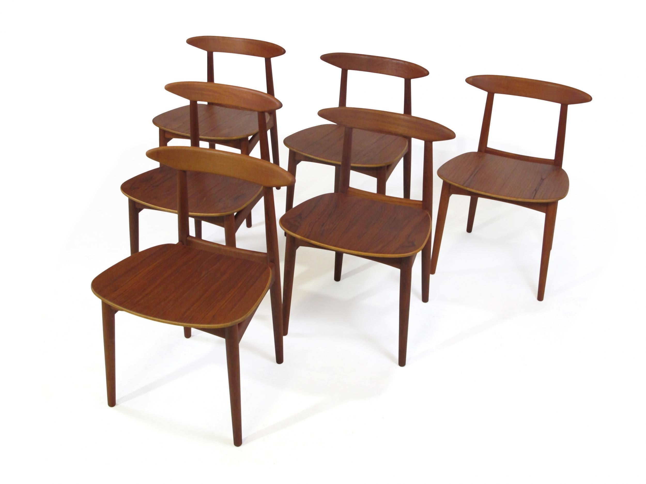 Six midcentury teak dining chairs attributed to Danish designer Kurt Ostervig. Solid teak frames, sculpted backrest with wood seats. The chairs have been professionally restored by our team of craftsmen. Excellent condition.