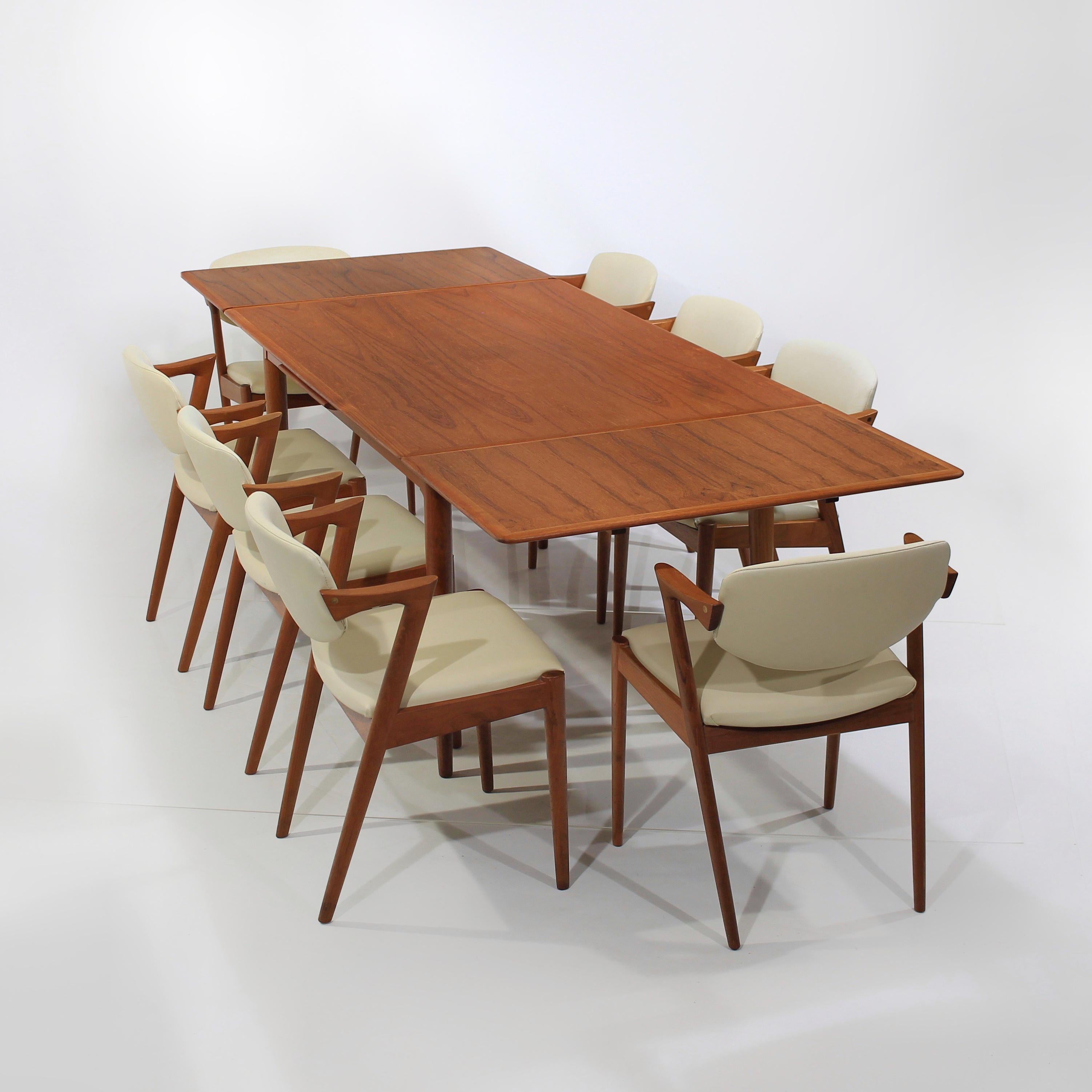 Presenting this beautiful dining set consisting of a Set of 8 Danish Modern Model 42 Teak Dining Chairs by Kai Kristiansen and Skovmand Andersen for Moreddi Dining Table with two leaves.

About the Table:

Rectangle Mid-Century Danish Modern