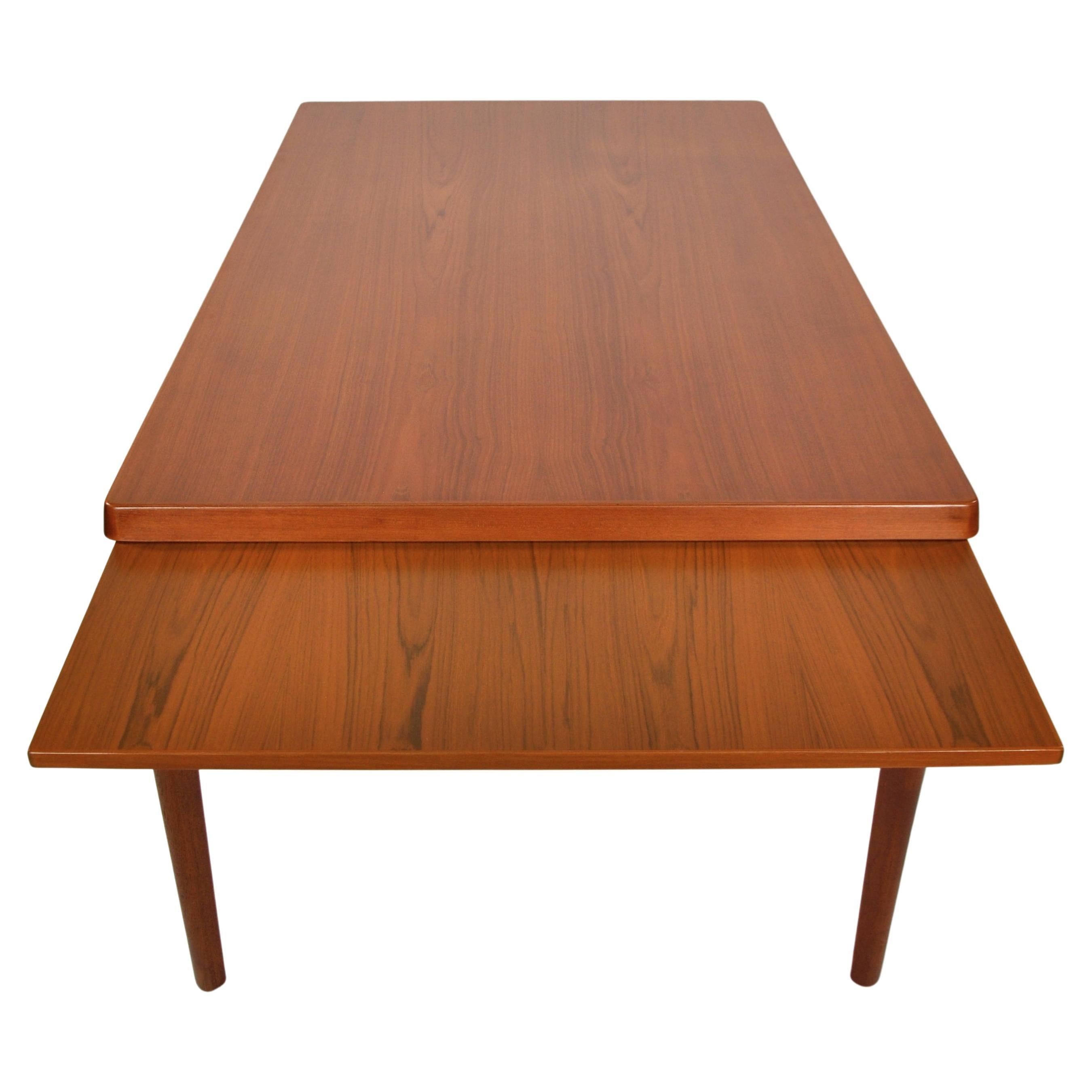 Clever and clean design in this mid-century Scandinavian Modern expandable dining table designed by Henning Kjaernulf, manufactured by Vejle Stole and Mobelfabrik in the 1960s. The table comfortably seats six when compact and extends to accommodate