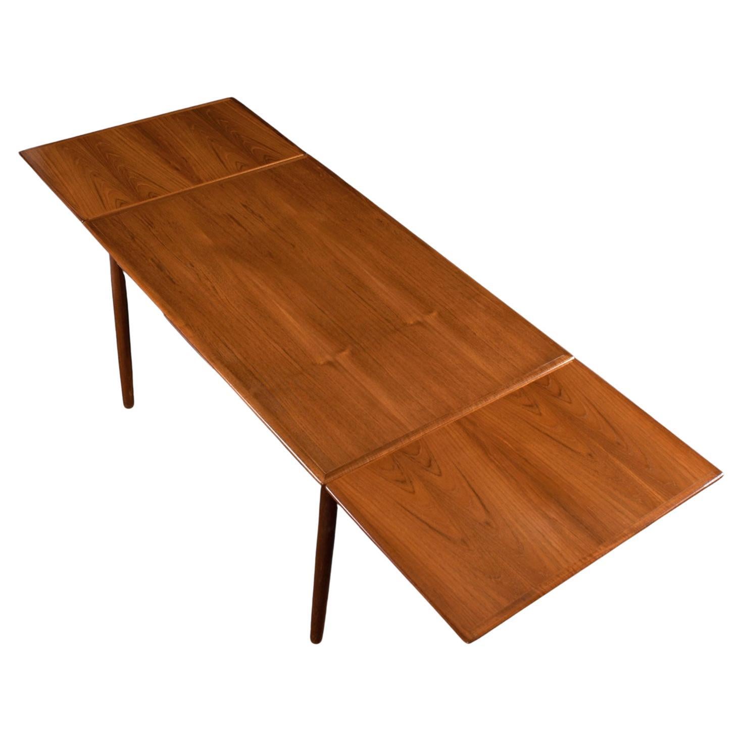 Gently restored by our in-house team. The top needed re-finishing but the leaves were left in original condition. More than likely, the leaves were rarely used. 

Perfect for smaller spaces, this medium sized Mid-Century Modern Danish teak dining