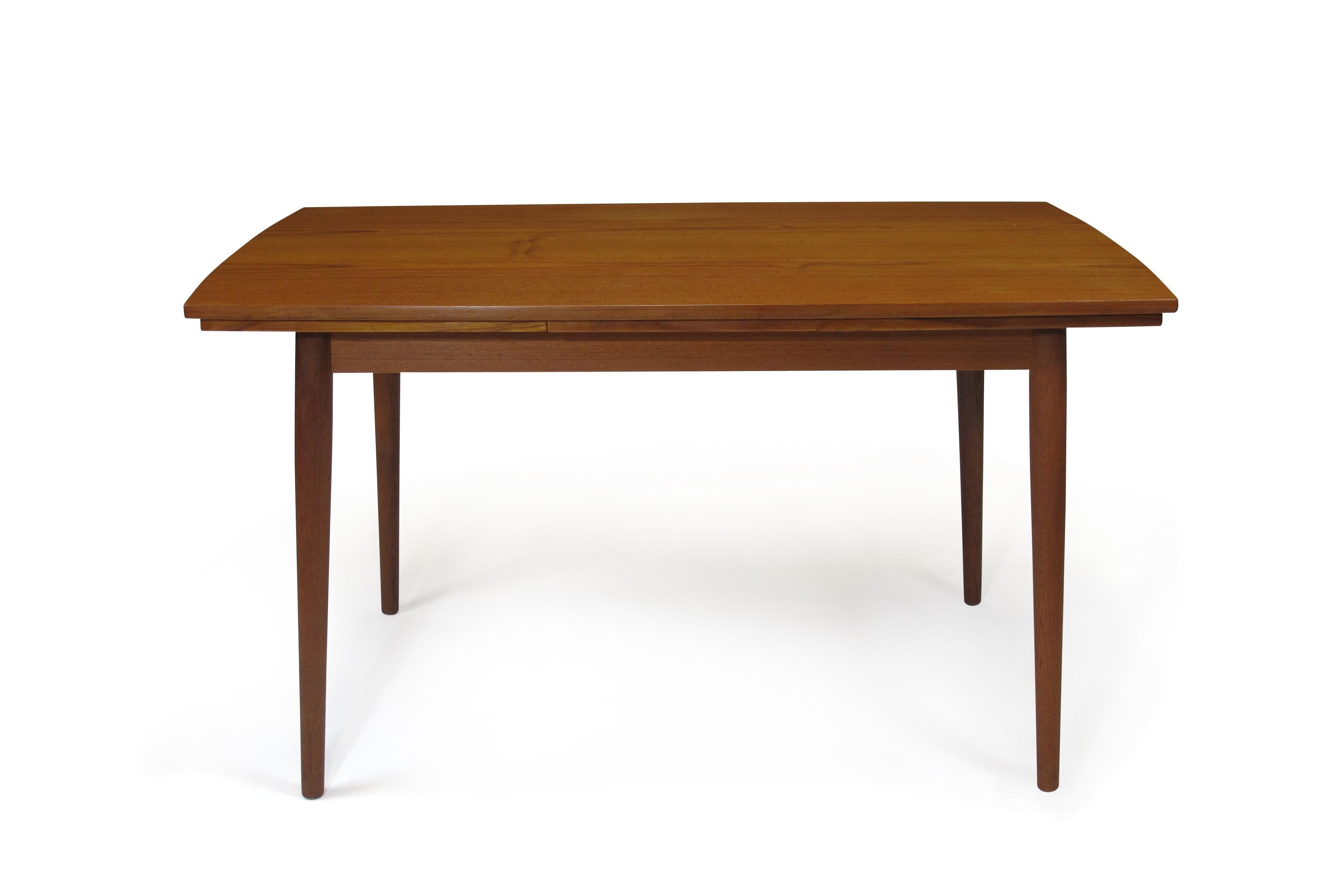 Draw leaf dining table crafted of old-growth teak. Finely restored and in excellent condition with minor sign of age use. Comfortable seating for 6-10 guests Each leaf 18.5