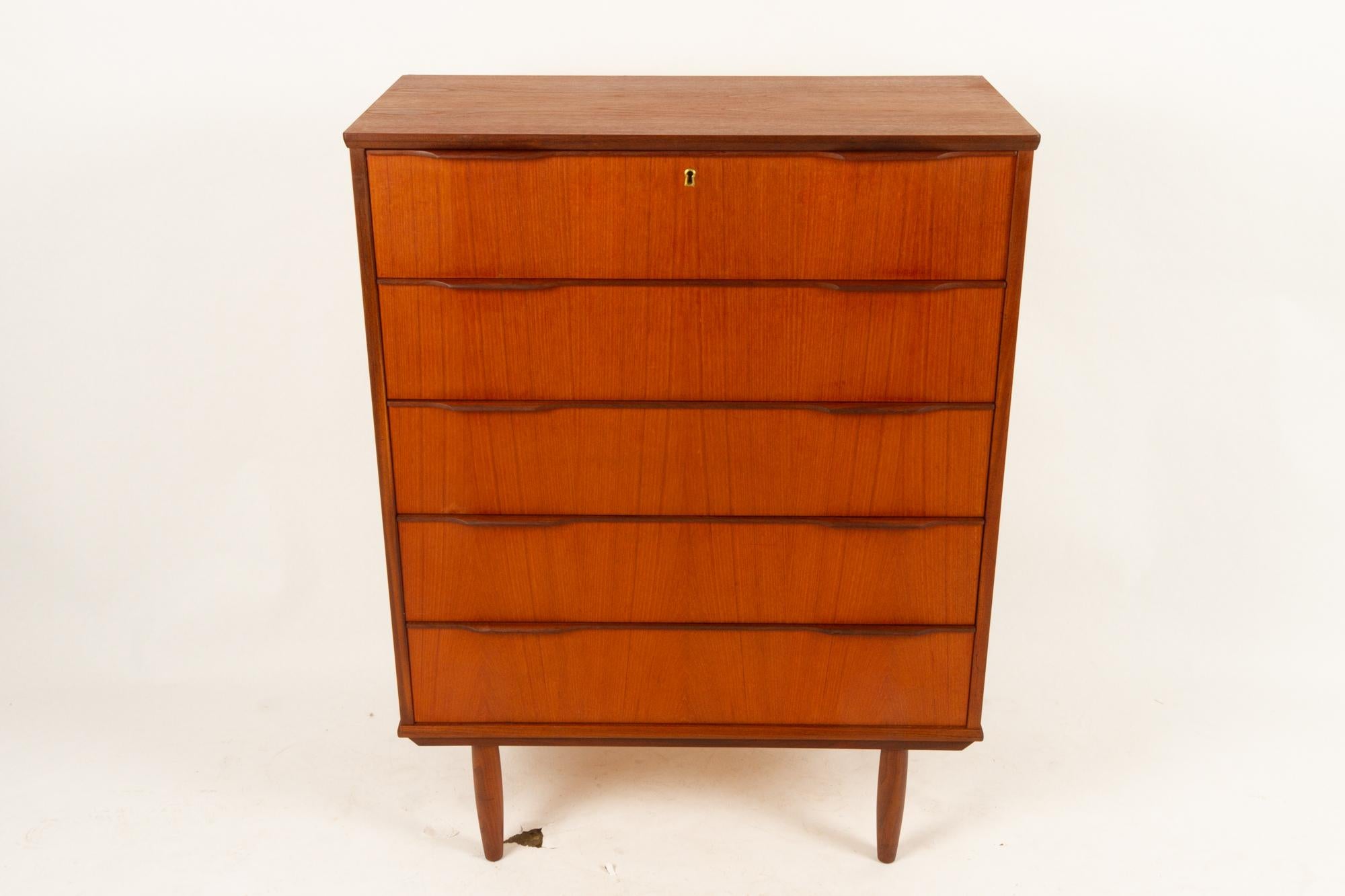 Danish teak dresser 1960s
Tall teak dresser with five large drawers. Top drawer with lock and key.
Long sculpted grips in solid teak. Round tapered legs in solid teak.
Beautiful veneer pattern on drawer fronts.
Very good vintage condition.
