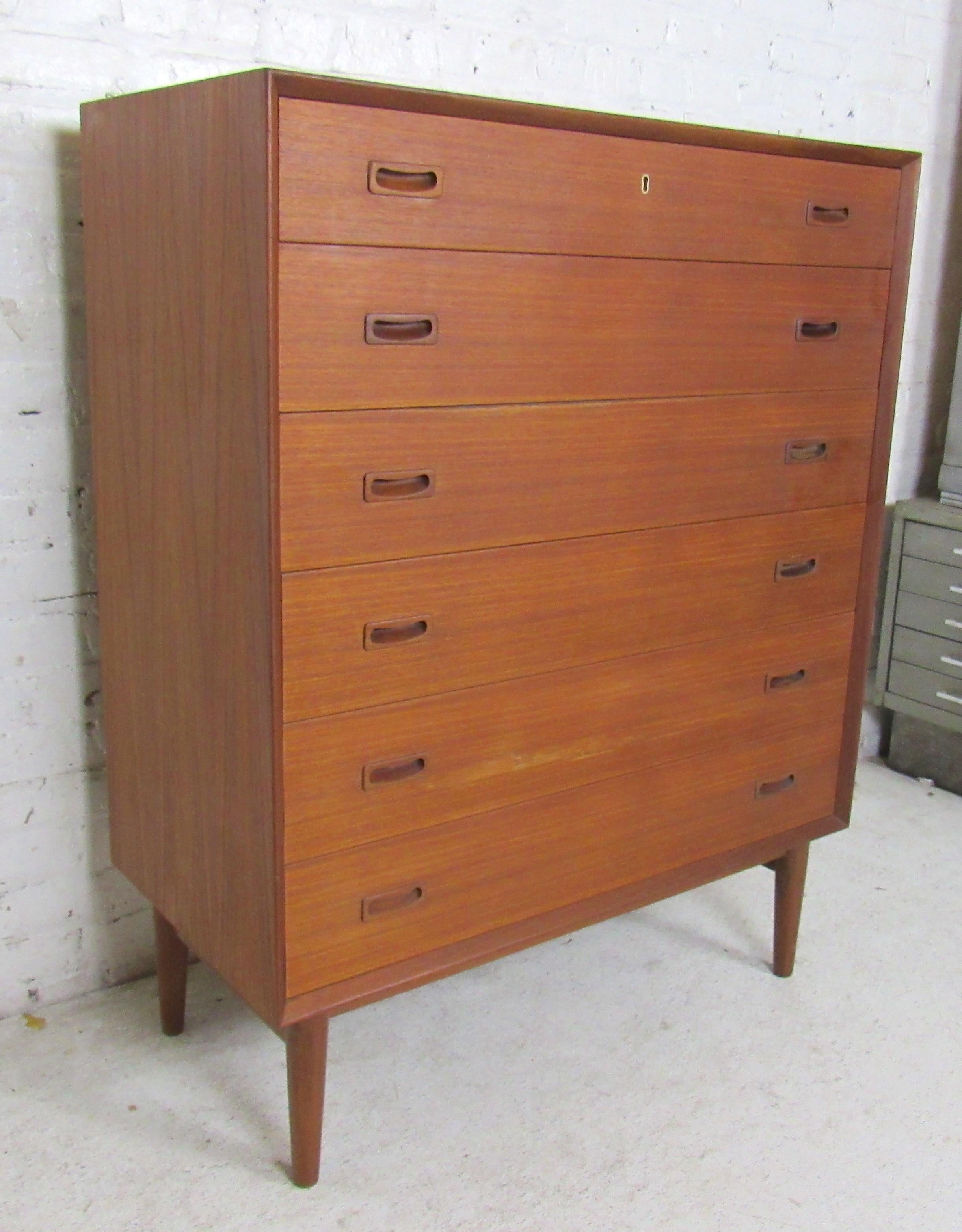 Tall chest of six drawers with sculpted handles and tapered legs.
(Please confirm item location - NY or NJ - with dealer).
 