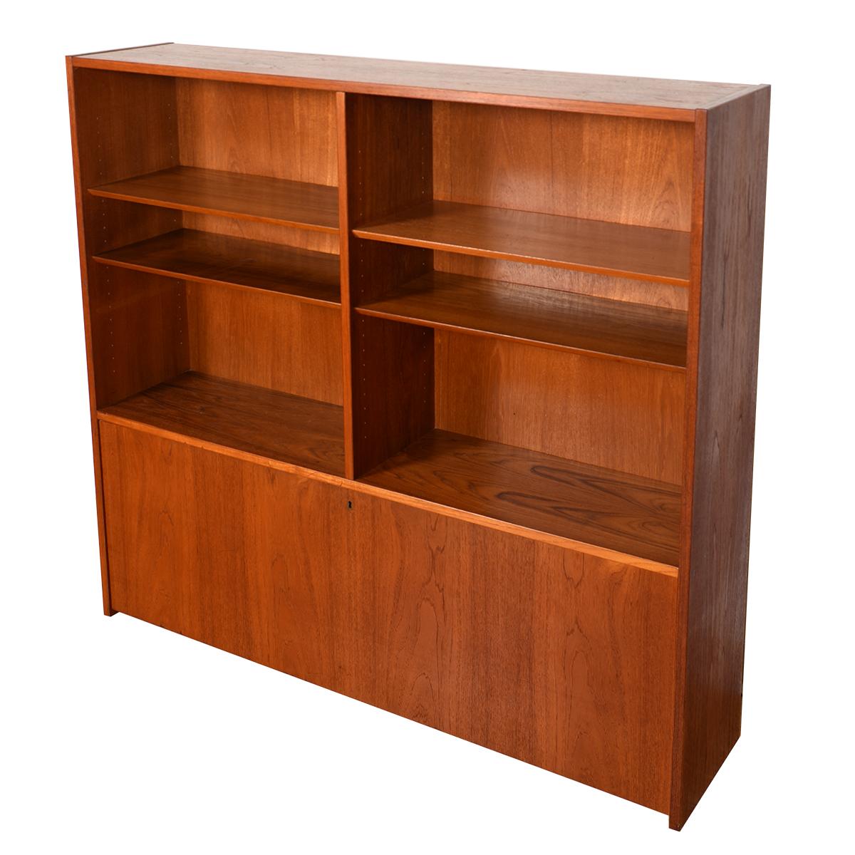 This Danish Modern teak bookcase display top will store your precious items in minimalist splendor. This piece can be set directly on the floor or can be placed atop a cabinet. The 4 teak shelves are all adjustable. Drop-down door has behind it 2