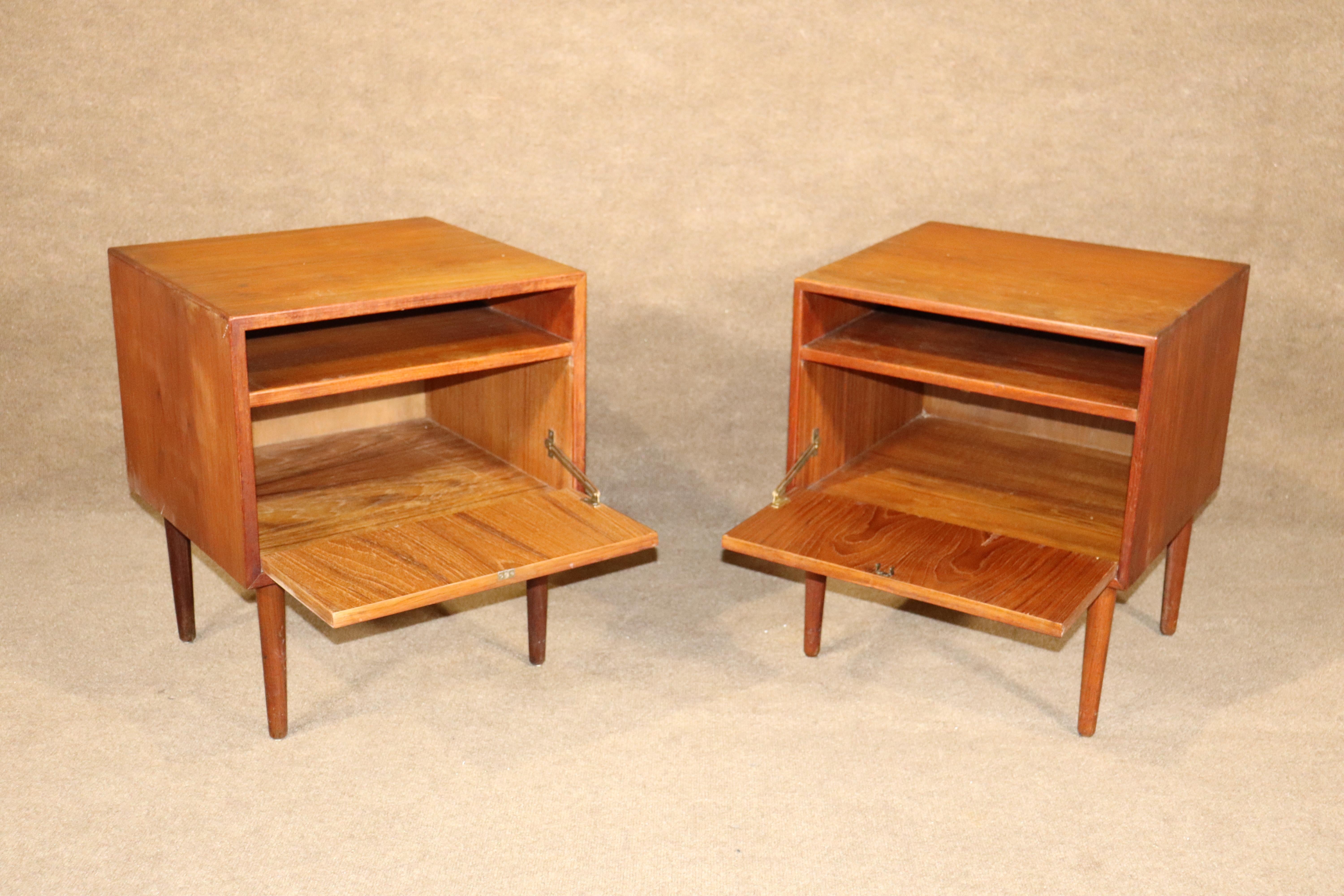 Pair of side tables by Falster with warm teak grain. Drop front cabinet storage and open storage above.
Please confirm location NY of NJ.