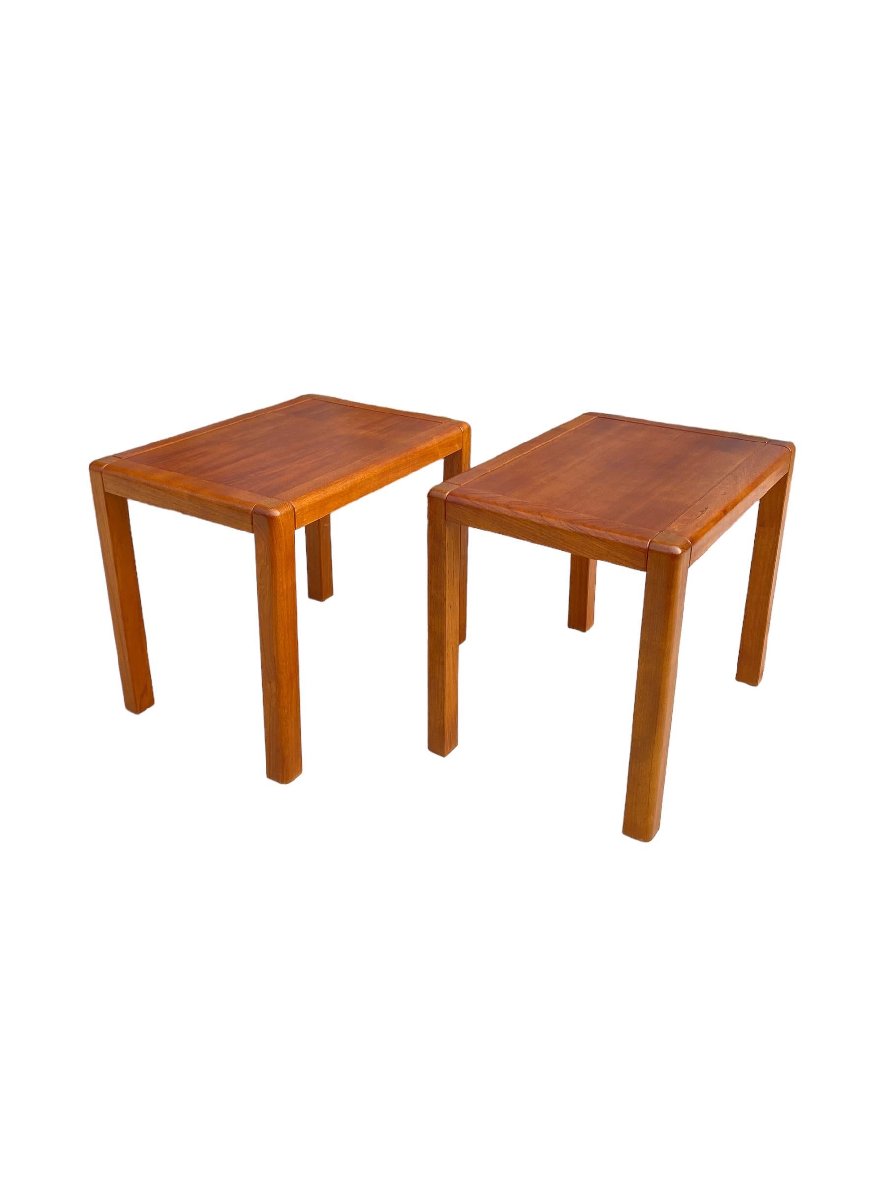 Pair of Danish modern teak end tables / bedside tables. Made in Denmark, these vintage tables have even grain and warm teak wood color. Sleek and minimal design. 