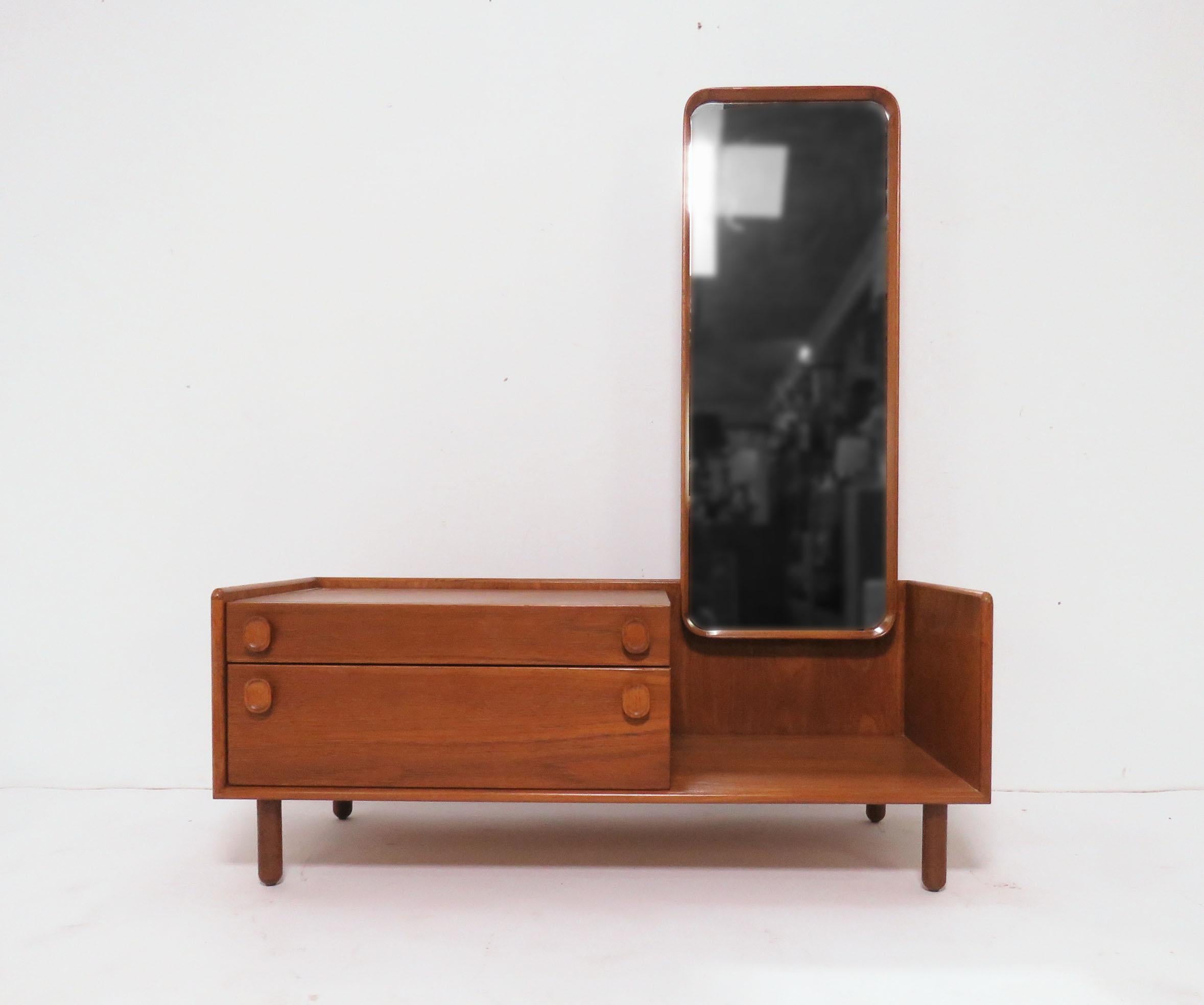 A Danish teak entry/hallway table, circa 1960s. Full length adjustable angle mirror for that last minute once-over before heading out in the morning, also functions well as a bedroom dressing stand with a handy pair of drawers.
Measures: 44