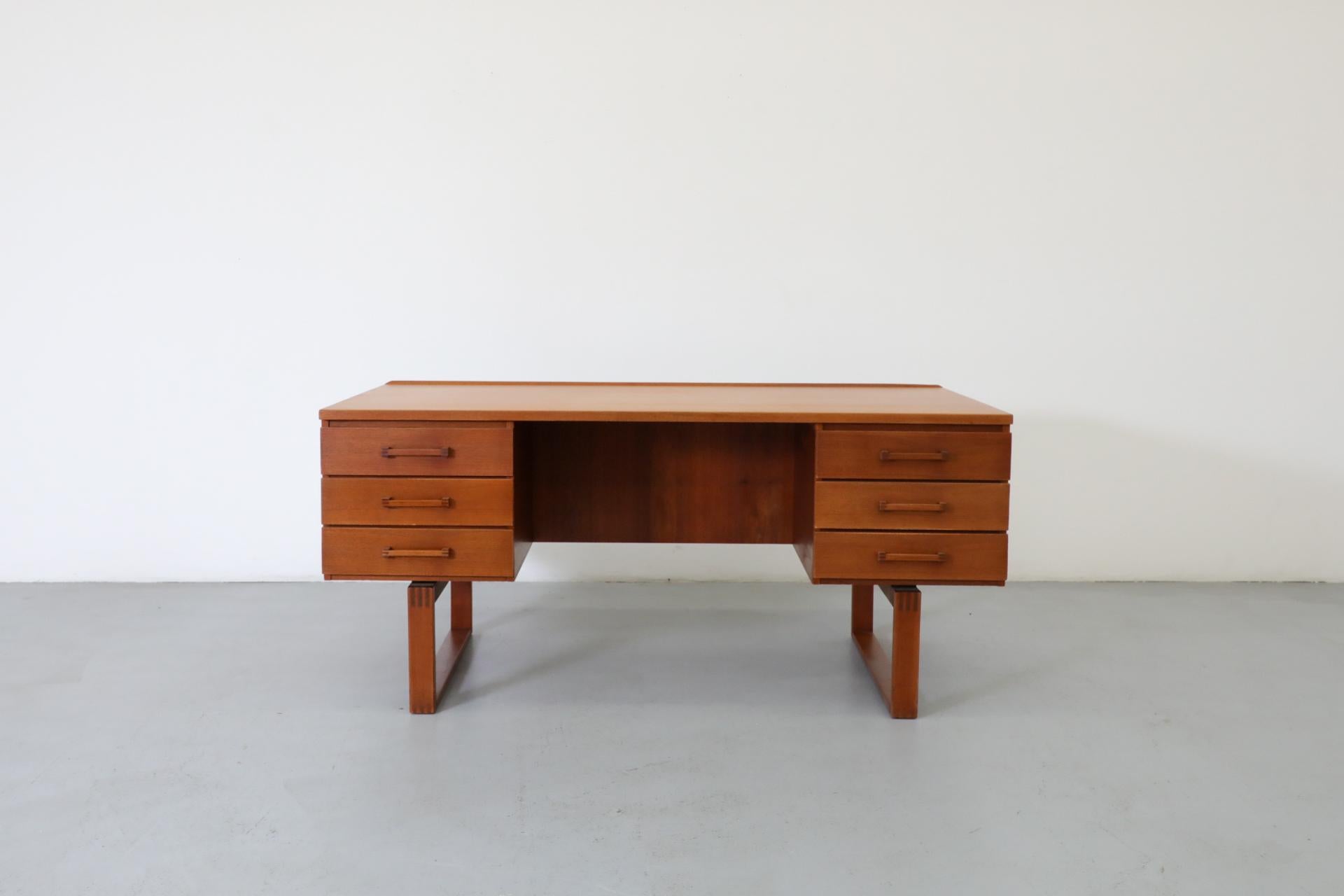 Mid-Century Danish teak executive desk by Henning Jensen & Torben Valeur for Dyrlund. 2 sets of three drawers and handsome Finger Joinery everywhere, including on handles. Lovely lip at back of desk surface and generous book cubby running the entire