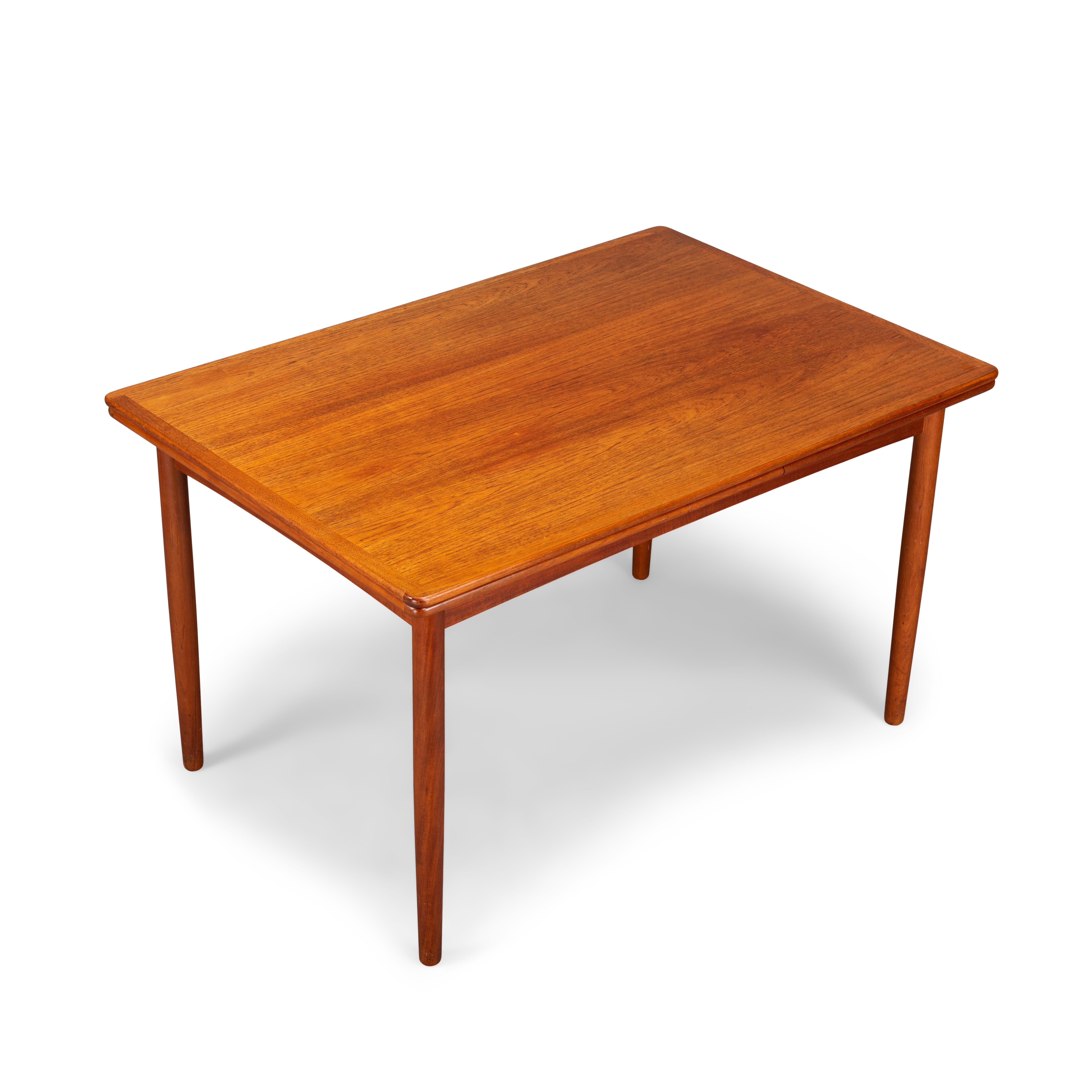 This Danish dining table was made in the 1960s. It features solid teak legs and two extension leafs which each measures 52 cm and extends the table to 2.30 cm. The extension leafs are hidden underneath the top. The color still matches really well