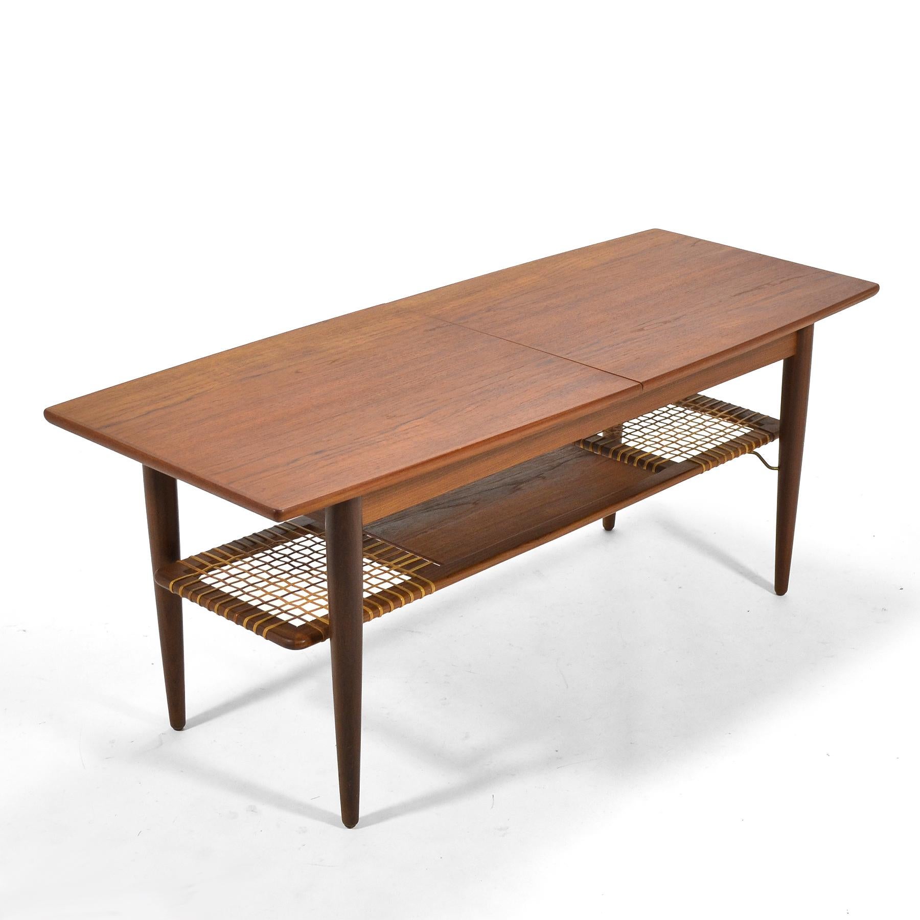 This exceptional teak coffee table has a top that expands with the addition of a 12