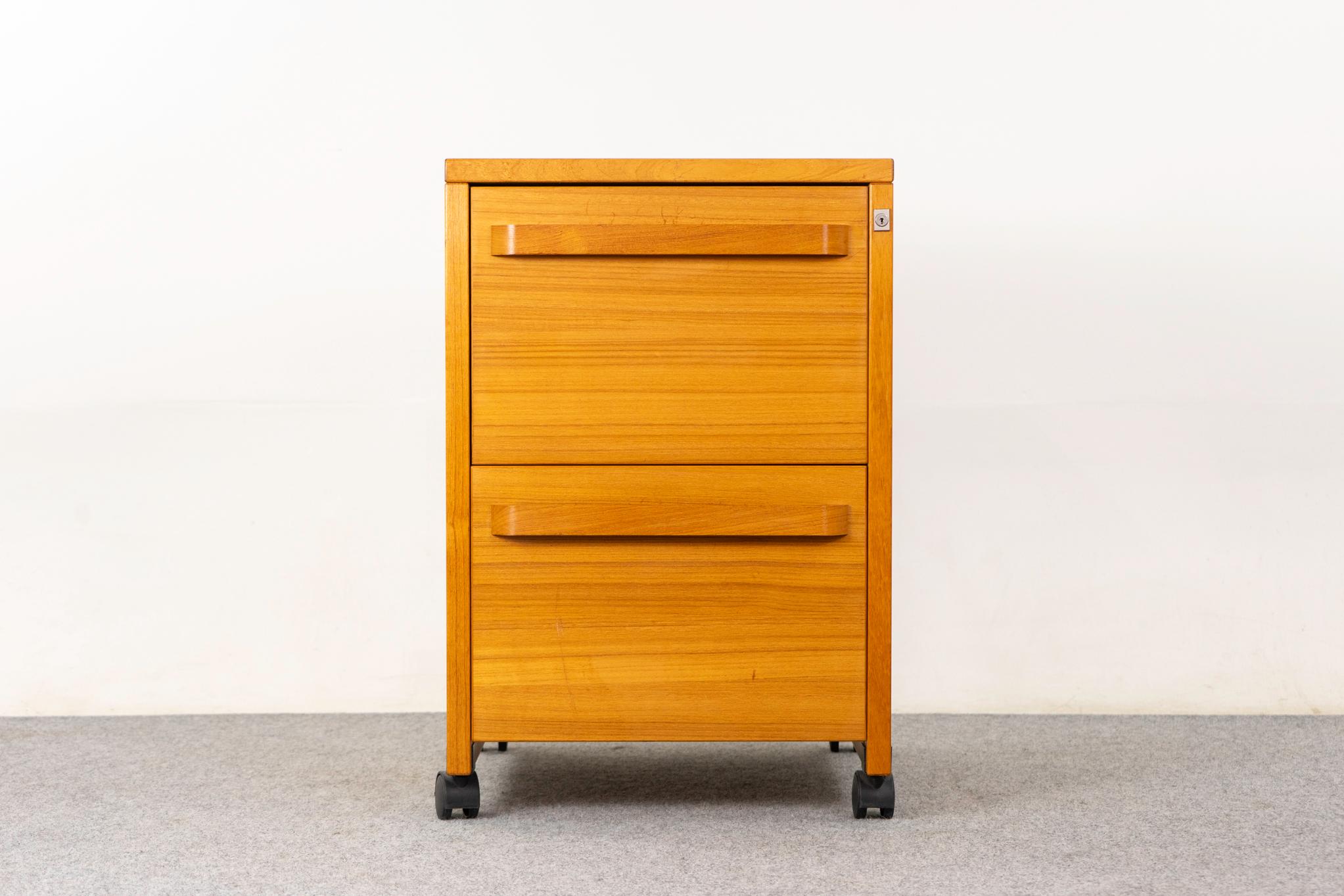 Teak file cabinet, circa 1970's. Robust cabinet with sleek handles, 2 hanging file drawers and original black casters. Great as is condition with only minor sun fading. Get organized! 

Unrestored item with option to purchase in restored condition