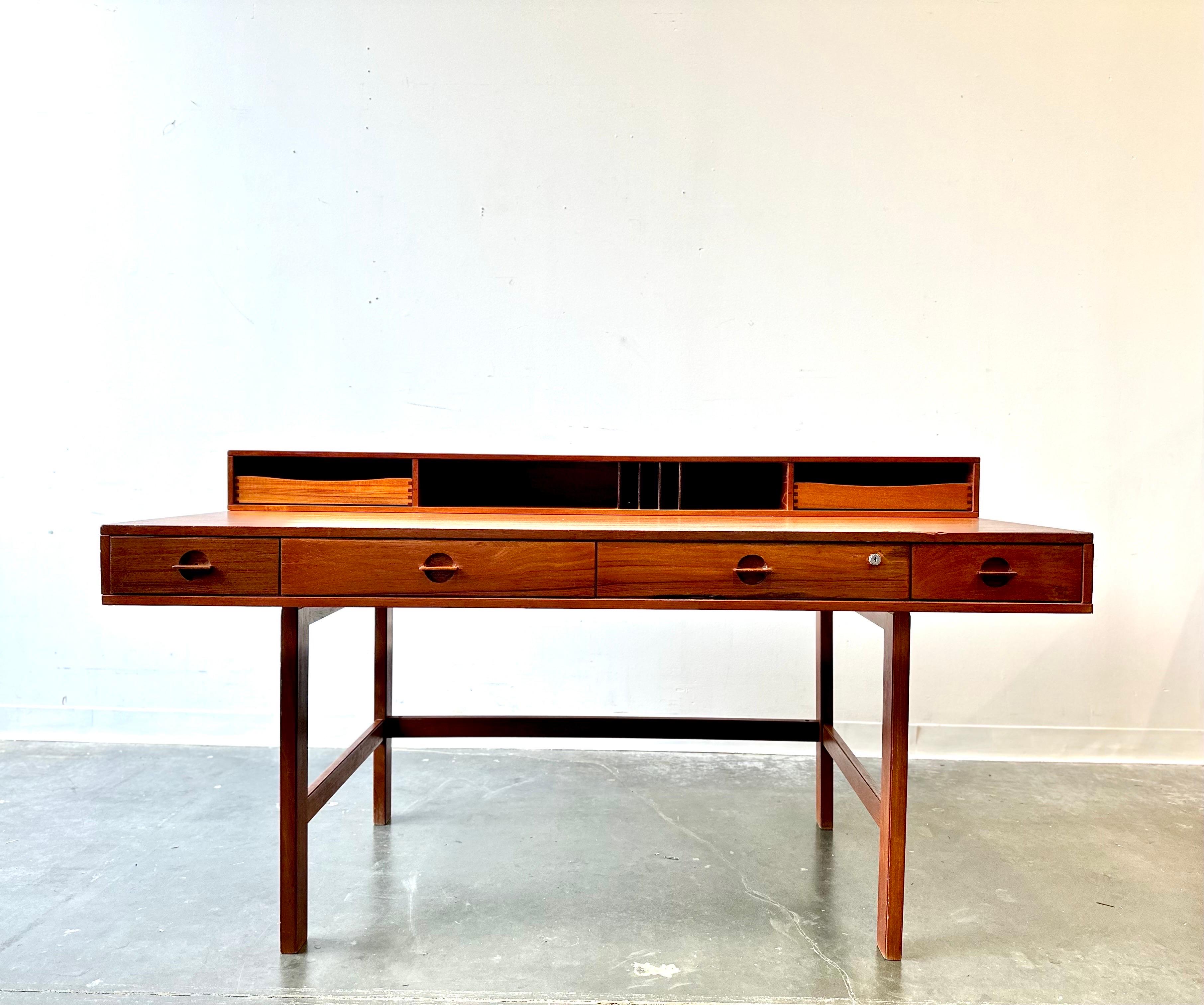 Peter Lovig Nielsen flip top desk.

Gorgeous teak desk that’s been freshly restored.
This has fantastic grain and a ton of desk top space and storage.

