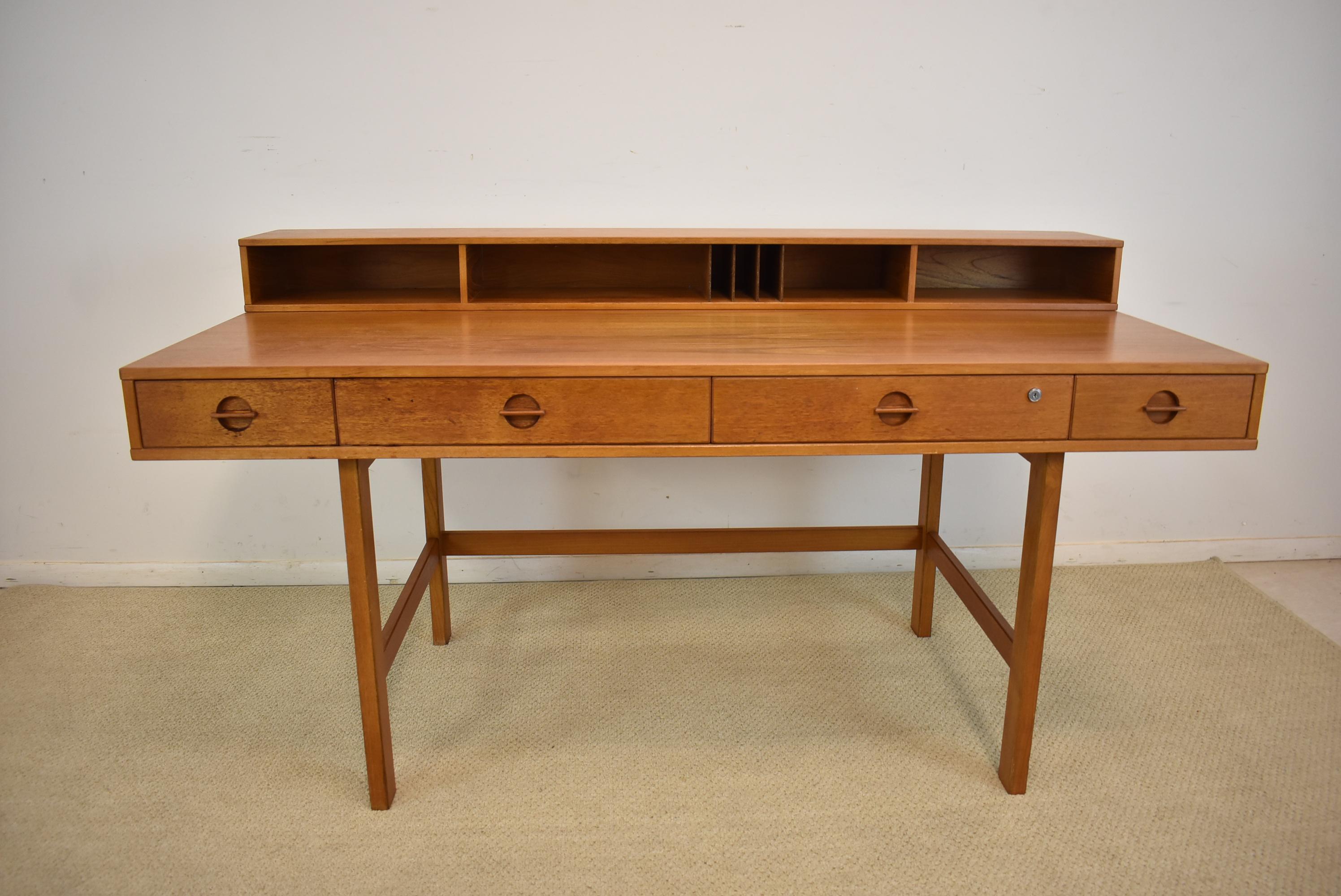 An incredible Danish modern teak partner's desk by Peter Løvig Nielsen. This desk has an amazing design. It features an upper cubical section that is hinged and can be flipped down to accommodate two people working at the desk in a partners fashion.