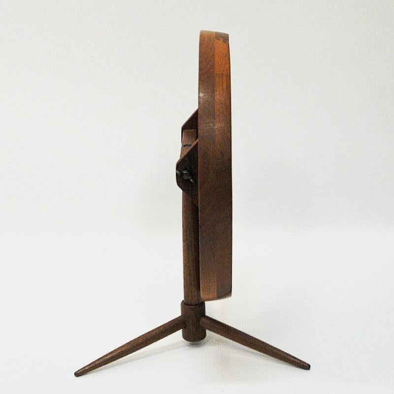 Lovely round teak table mirror flip-top function by Pedersen & Hansen, Denmark, 1960s. Perfect on your hall drawer, bedroom, bathroom or kitchen bench. Angle of mirror is adjustable and it swivels around. Base with three legs. The mirror is of good