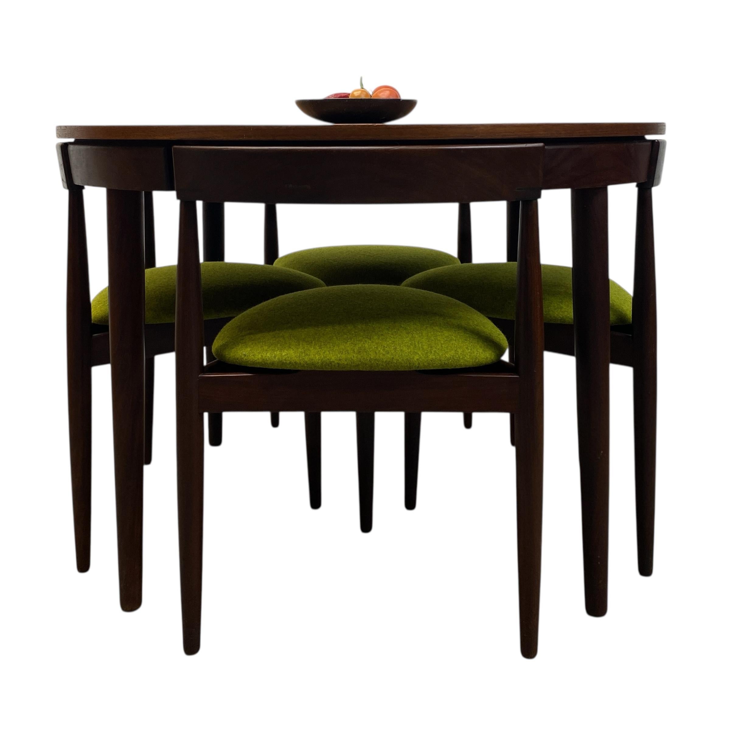 A midcentury Danish teak 'Roundette' extending dining table & four dining chairs designed by Hans Olsen for Frem Rojle, Denmark, dated circa 1960s. The stunning teak dining table has a very stylish shape & design. The dining set consists of a