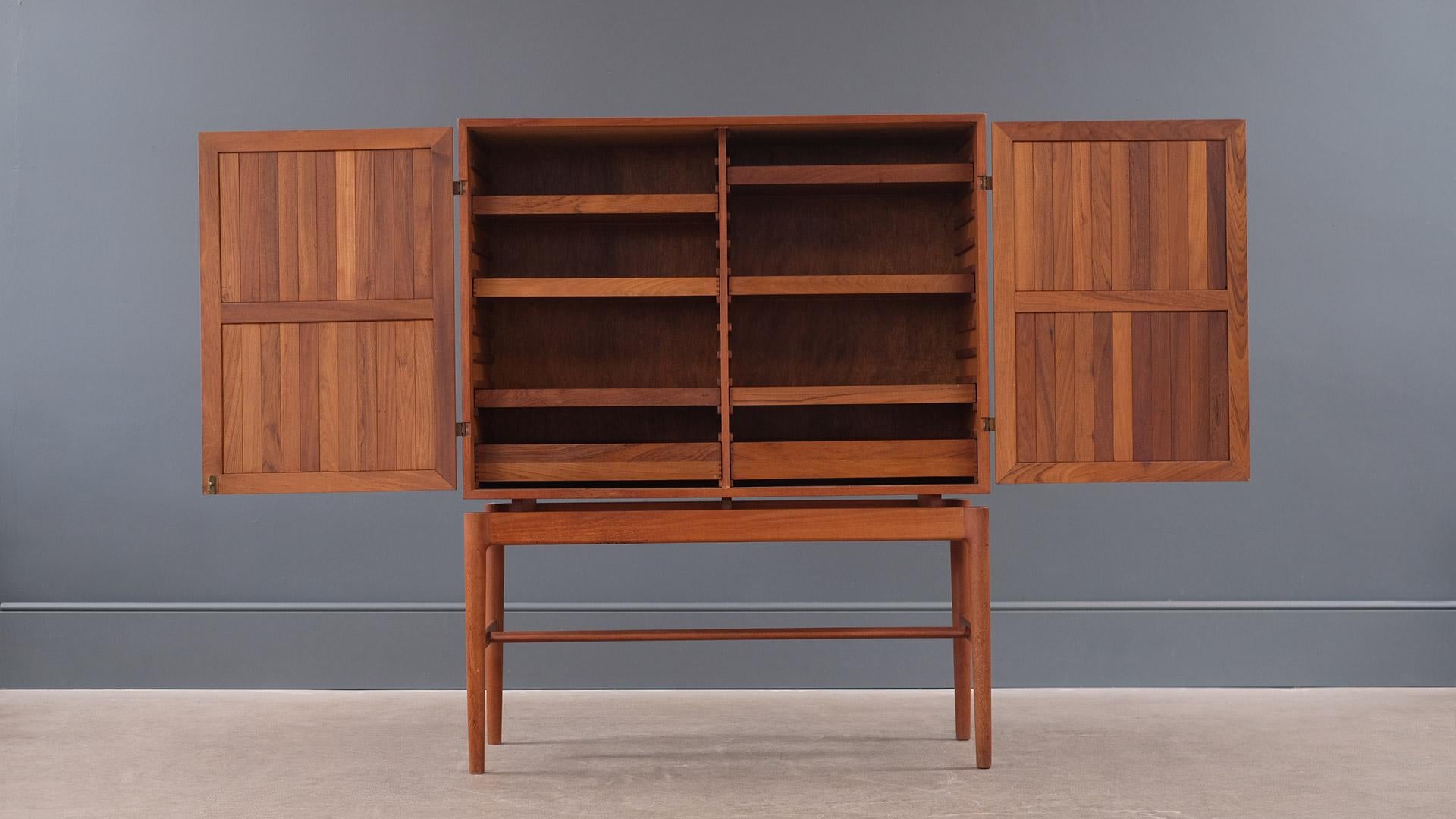 Outstanding 1950s linen cabinet in teak with exposed brass hinges by a Danish cabinet maker. Ultra high quality and in mostly solid timber this piece is super elegant and has real presence. Beautiful.