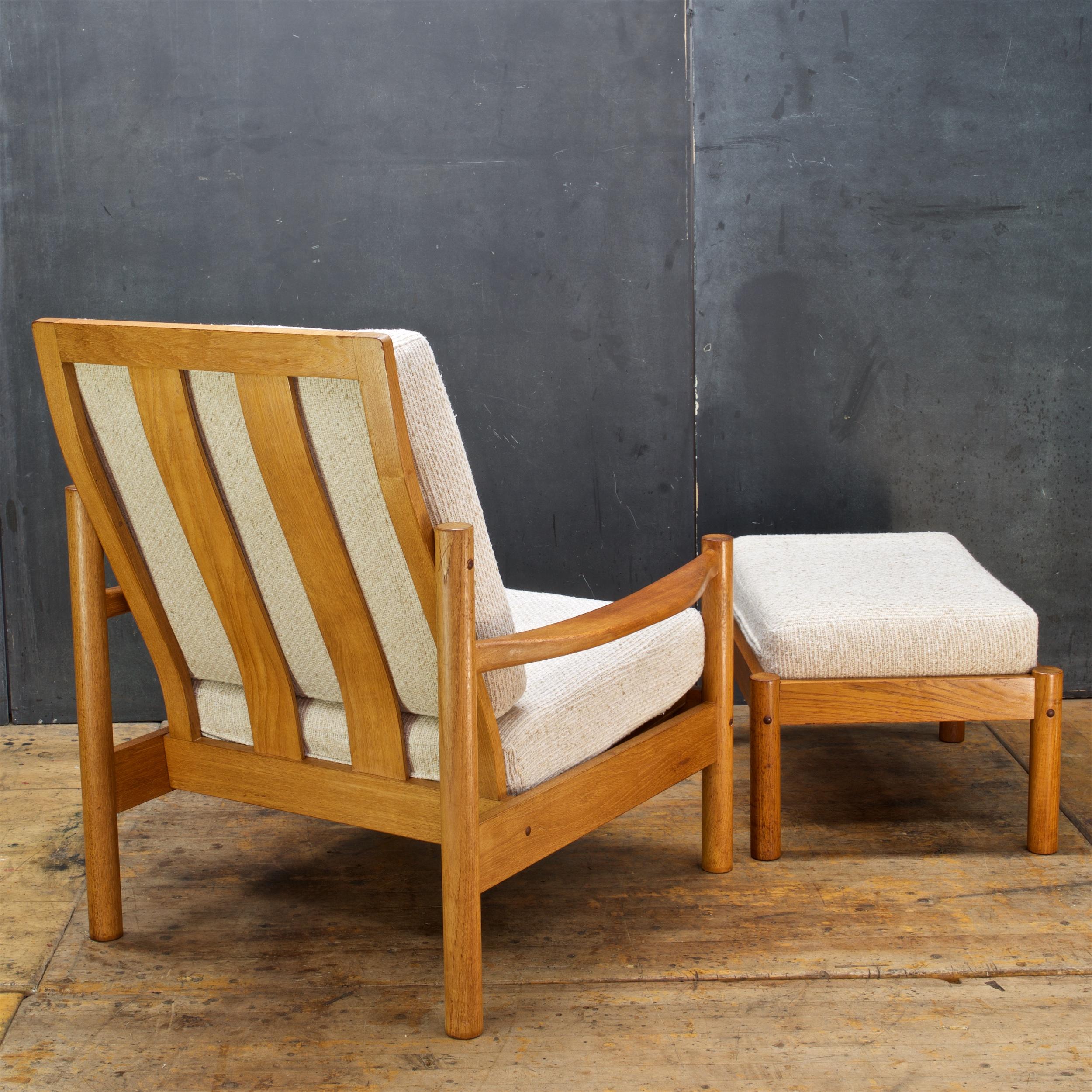 Wonderful solid warm-hued teak armchair and ottoman made in Denmark in the late 1960s or early 1970s. Original fabric is clean and usable, but older.

Ottoman W 26 x D 19.5 x H 12 in. ( H with Cushion 15 in.)