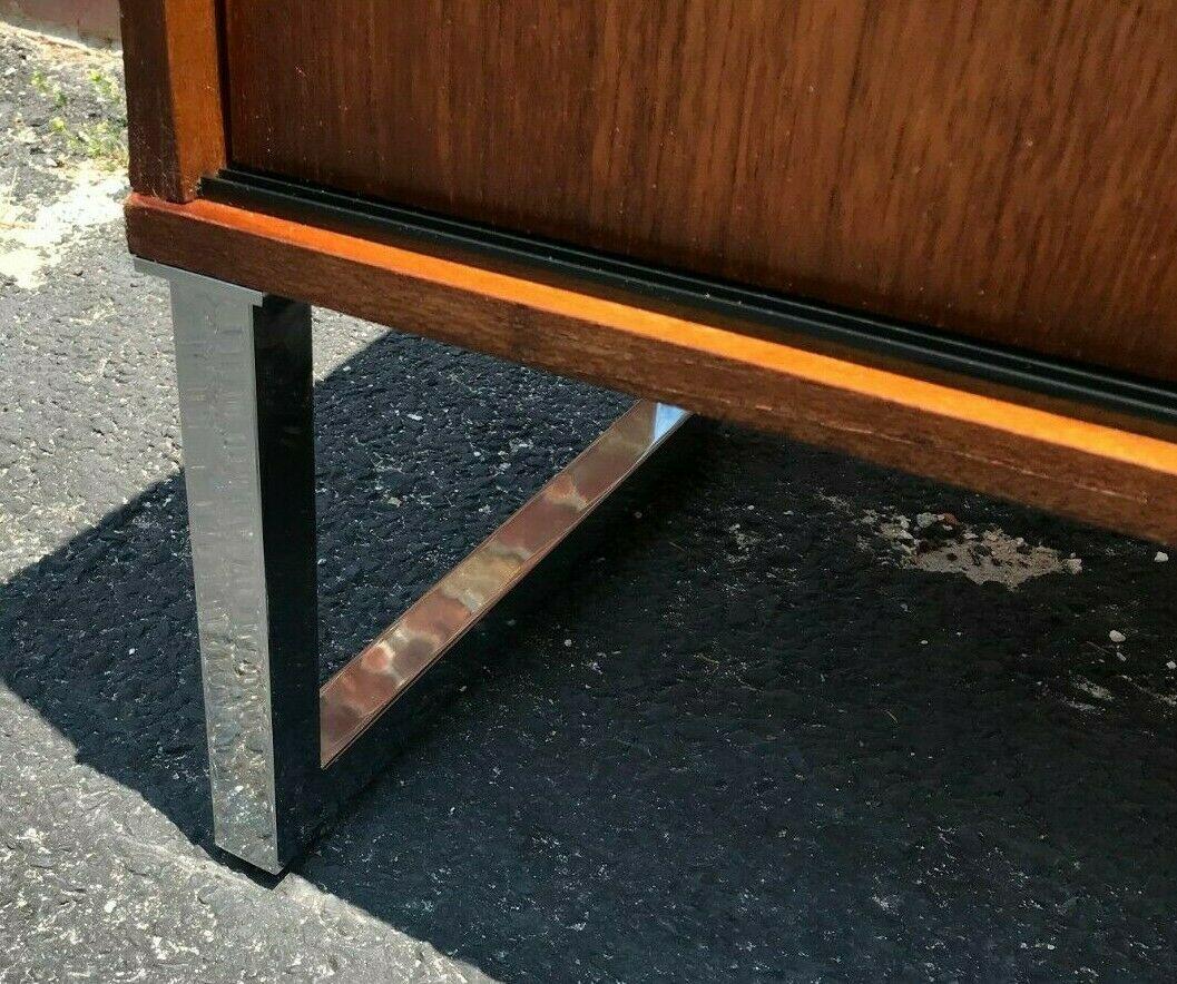 Danish Mid-Century Modern sideboard credenza record cabinet. Sliding doors reveal storage for LP's and all held up by 2 very sturdy chrome metal legs, feet are adjustable.