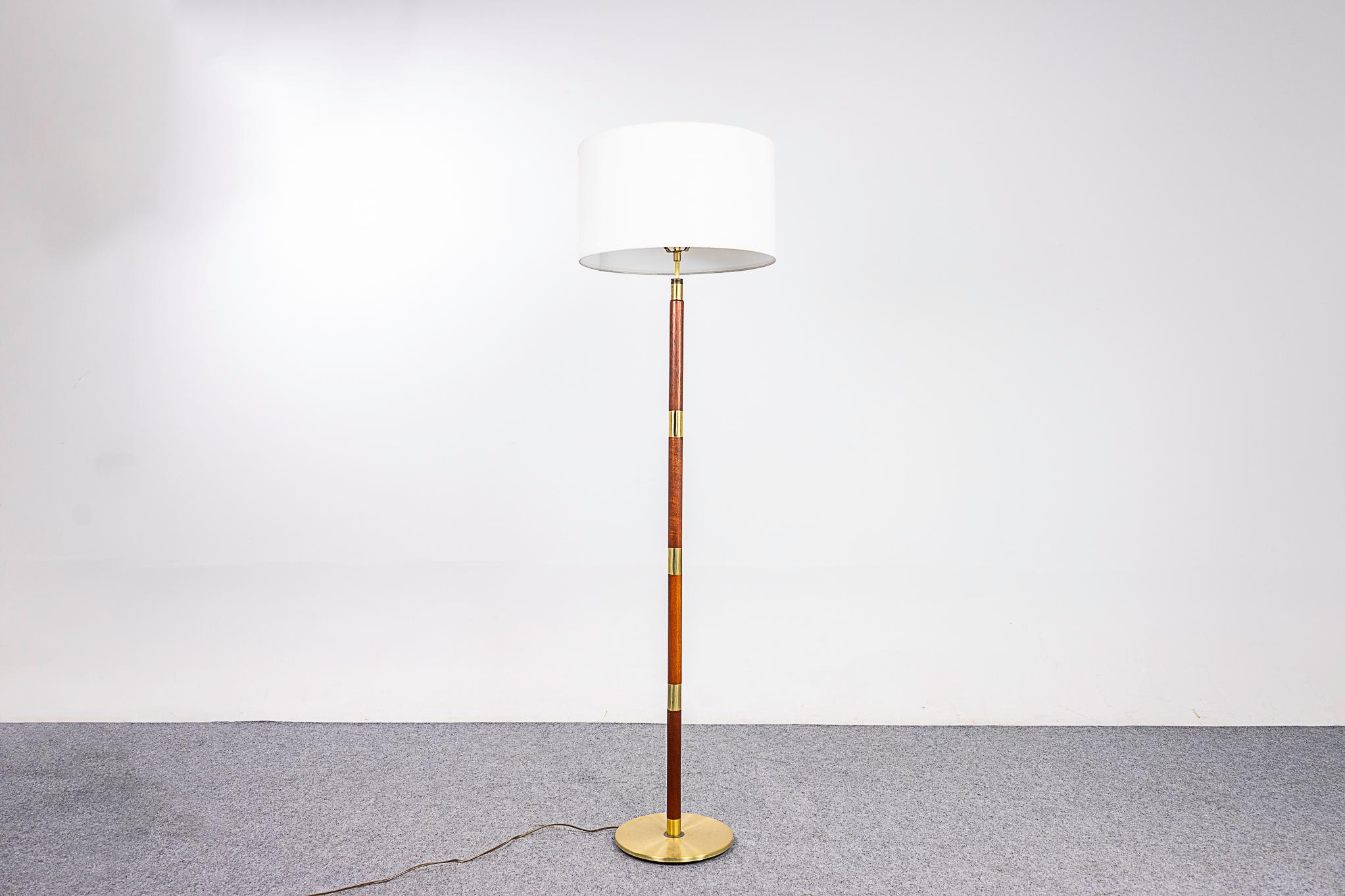 Teak & metal Danish floor lamp, circa 1960's. Beautiful solid teak construction with metal accents New quality custom shade. Re-wired for 110V, tri-light socket allows for 3 brightness settings. Neck adjusts to set your desired height, 57' to
