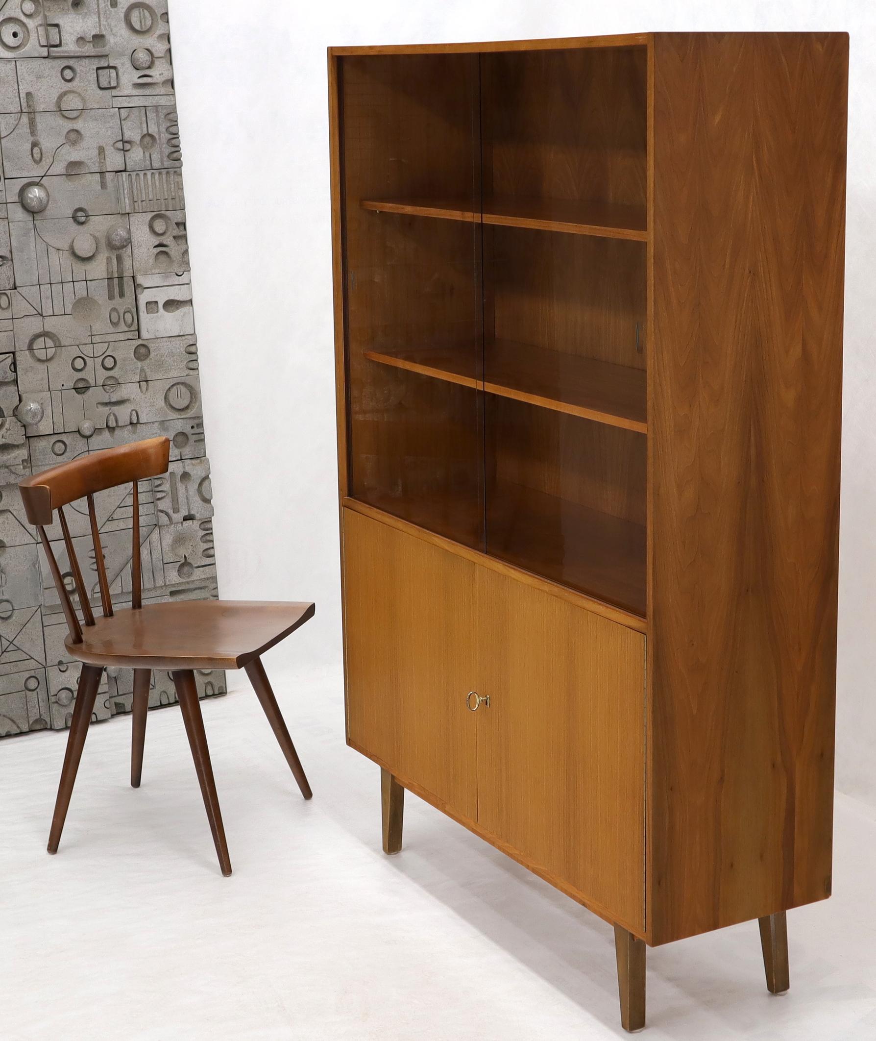 Midcentury Danish modern three shelves bookcase hutch credenza cabinet with two sliding glass doors and cabinet doors on the bottom. The bottom compartment lock works and come with the key.