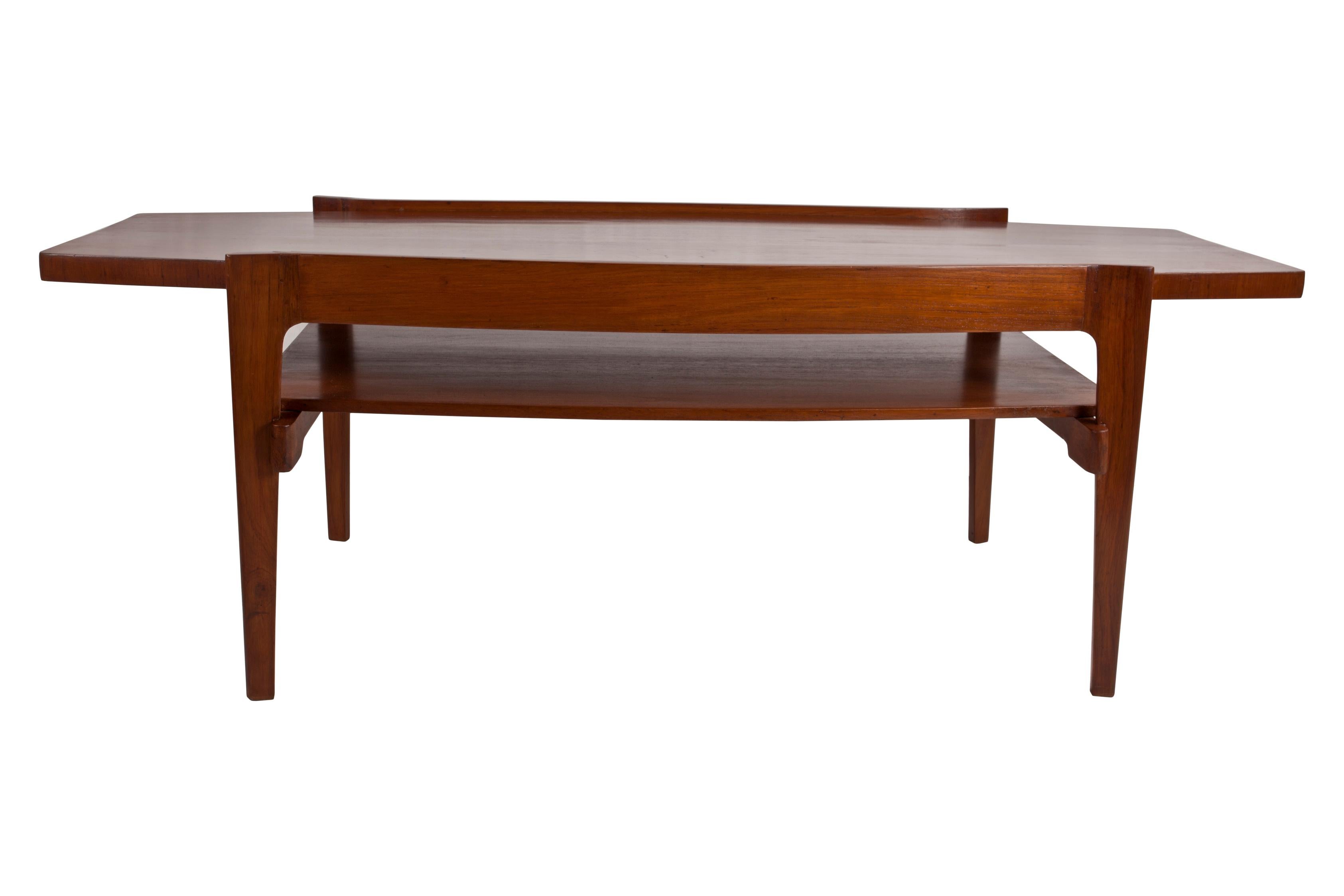 Mid-Century Modern teak coffee table, Danish. Lower shelf, tapered top and flared edges. Distance between the shelf and the top is 4 inches.