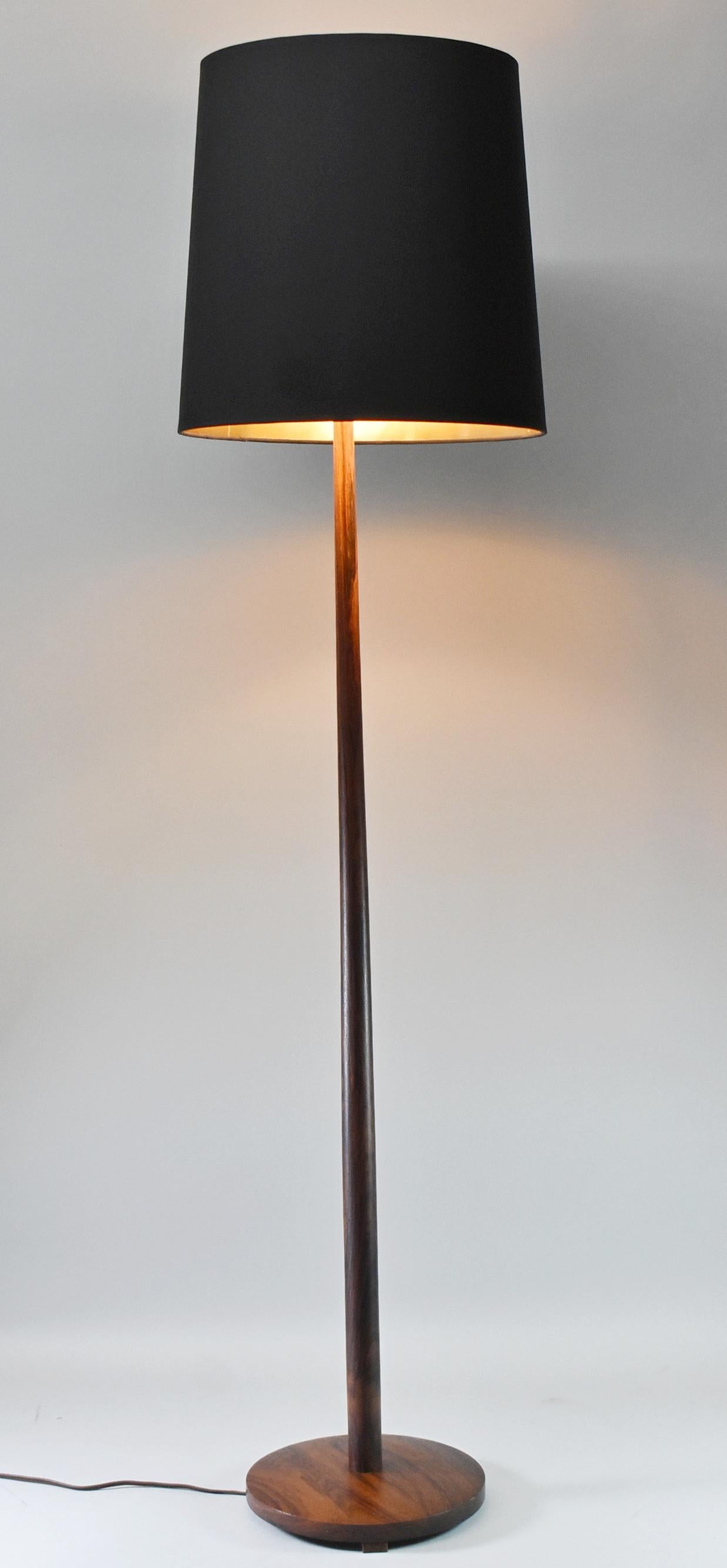 Mid-century modern Danish teak floor lamp by Kovacs. This lamp features a new shade and has been rewired. It is stamped SI 621 and labeled Made in Sweden. Very nice condition with a few dings on the base as shown. 56