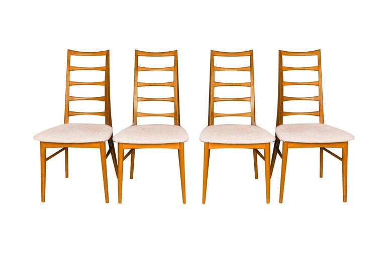 An outstanding set of six teak dining chairs designed by Niels Koefoed for Koefoeds Hornslet, model “Lis” made in Denmark, circa 1960's. This stunning set of six ladder back teak chairs features two arm chairs and four side chairs in original
