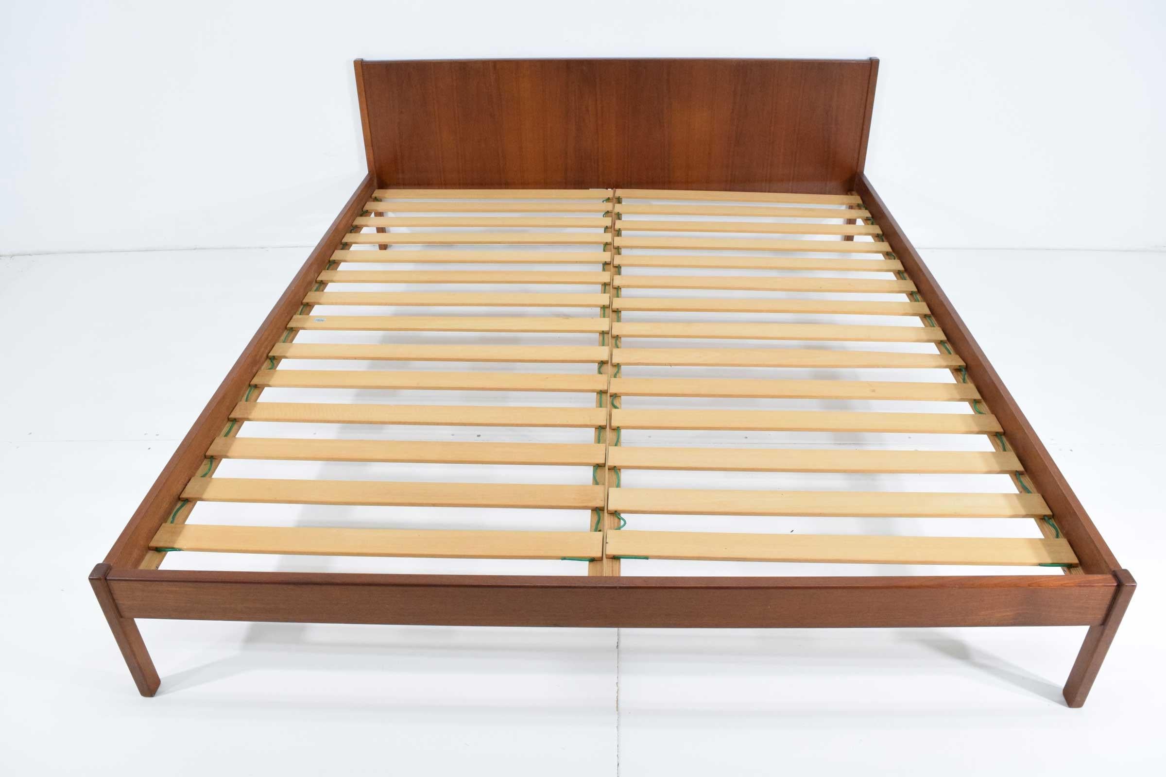 Beautiful teak bed frame from the 1960s. Includes headboard, footboard and running boards with wood slates.