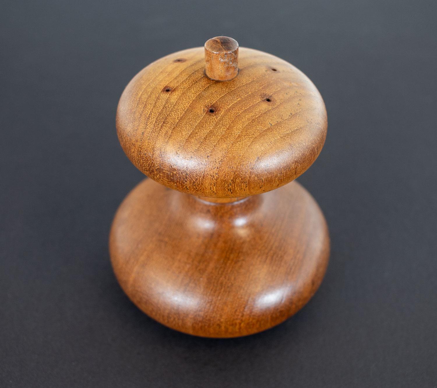 Teak pepper mill and salt pot designed by Jens Quistgaard, a Danish sculptor and industrial designer, in the late 1950s for Dansk Designs. This is model 822 which is an hour glass shape with the pepper grinder at the bottom and salt dispenser at top