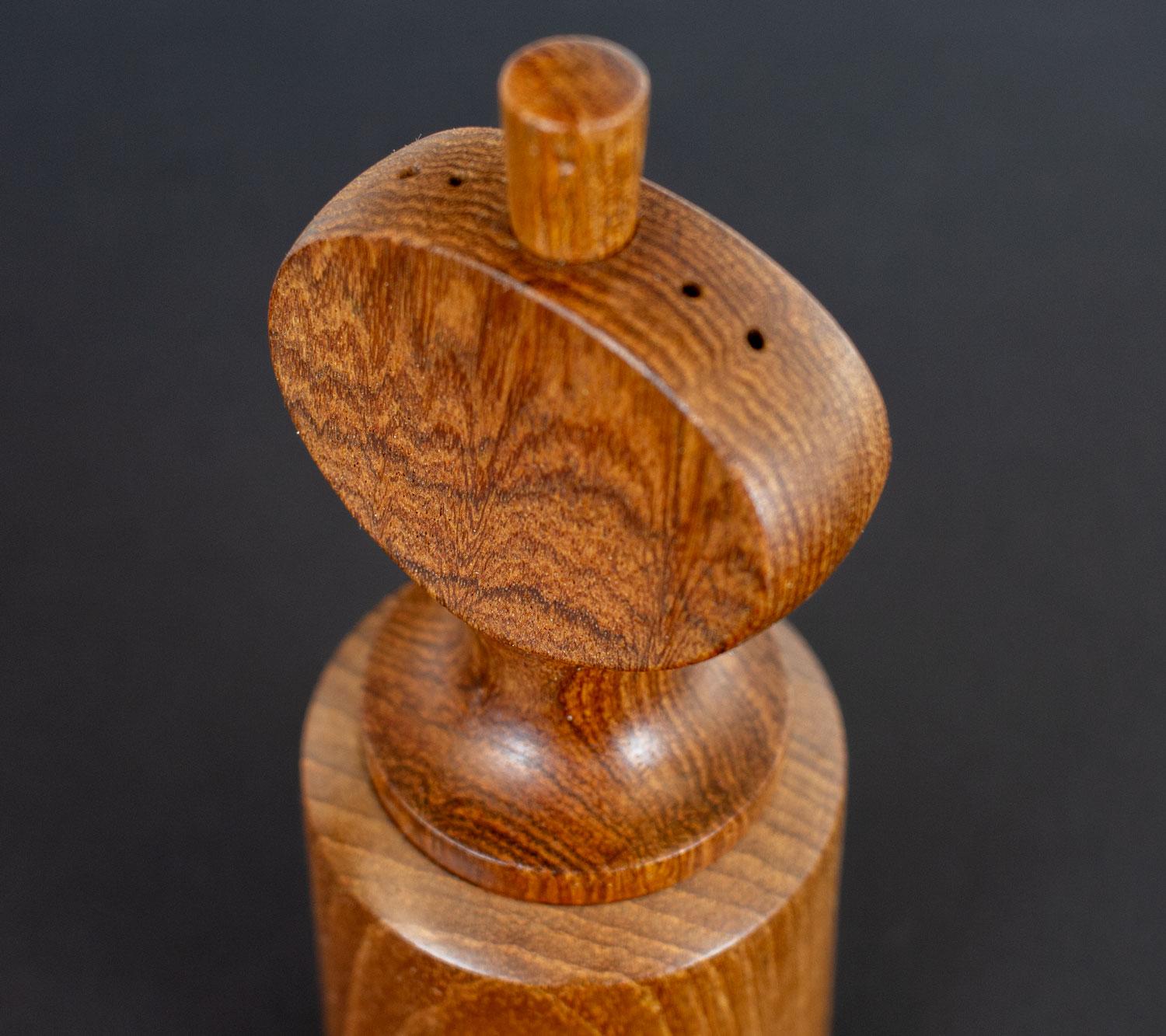 Teak pepper mill and salt pot designed by Jens Quistgaard, a Danish sculptor and industrial designer, in the late 1950s for Dansk Designs. This is model 833 which has a straight sided pepper grinder at the bottom with an oval salt dispenser at the
