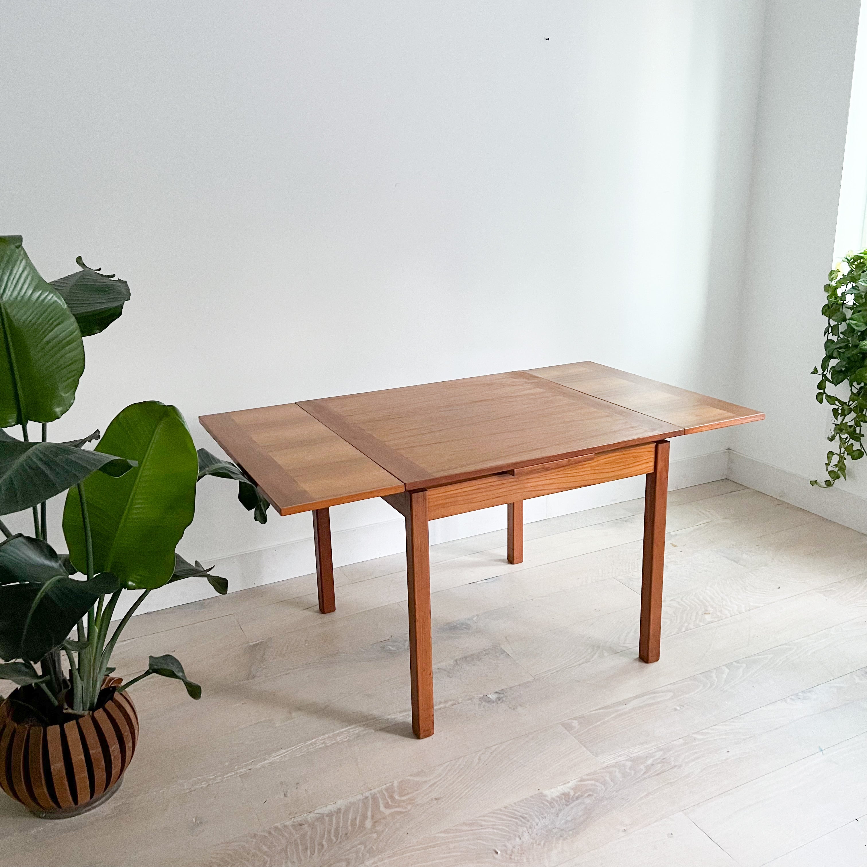 Elevate your dining space with this exquisite Danish teak dining table. Crafted to perfection, its compact 33.5”x33.5” size effortlessly accommodates intimate gatherings.

Condition: The original finish displays subtle scuffing, scratching, and