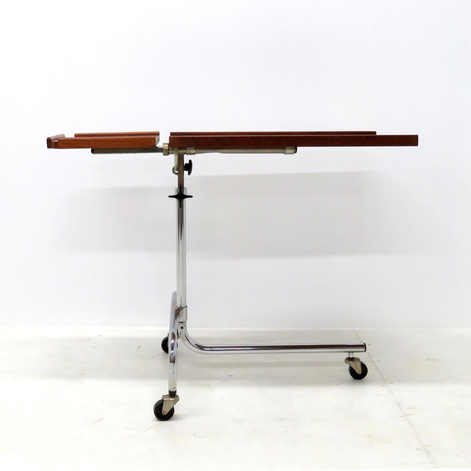 Great original 1950s Danish mobile reading or serving table by HMN Denmark, two teak trays on a chrome plated frame with three casters, adjustable in height (24