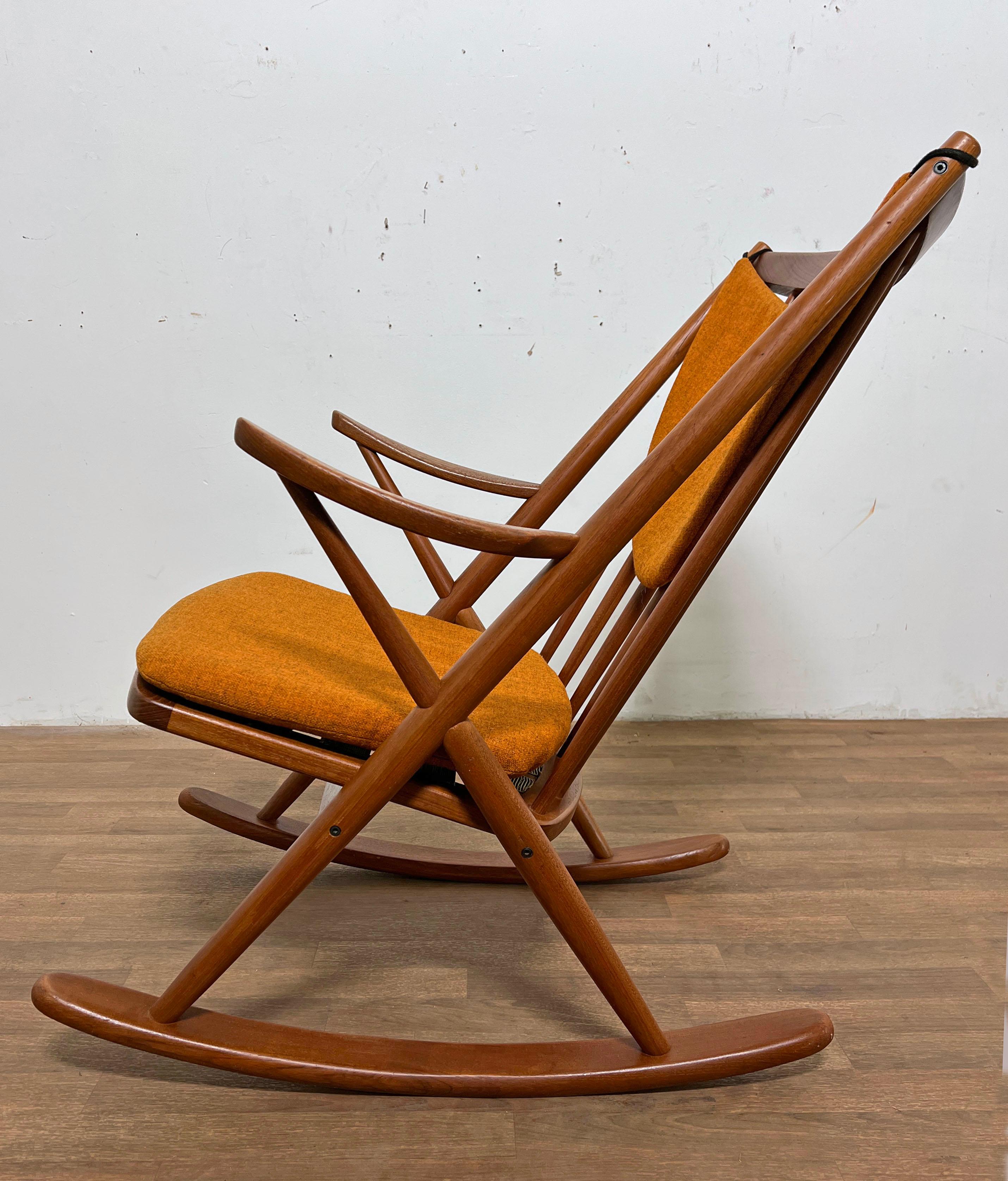 Classic teak rocking chair by Frank Reenskaug with original upholstered seat and back cushion, in fine and supple condition. Designed for Bramin Møbler, circa 1960s.