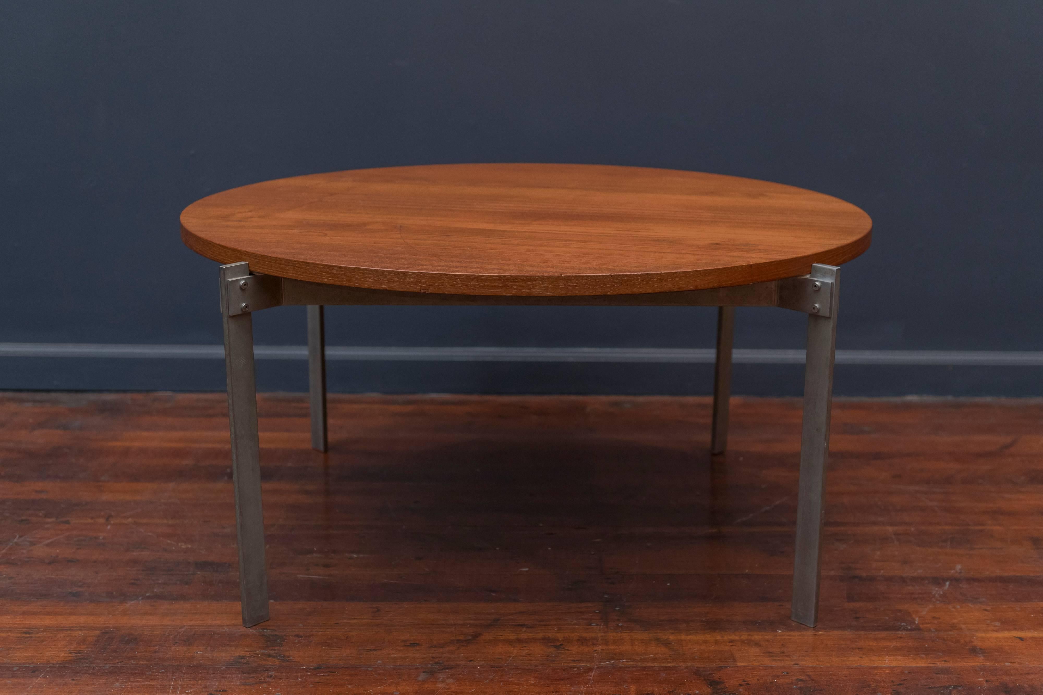 Unusual Danish teak and metal round coffee table. High quality craftsmanship and design in very good original condition with a light patina to the metal base.