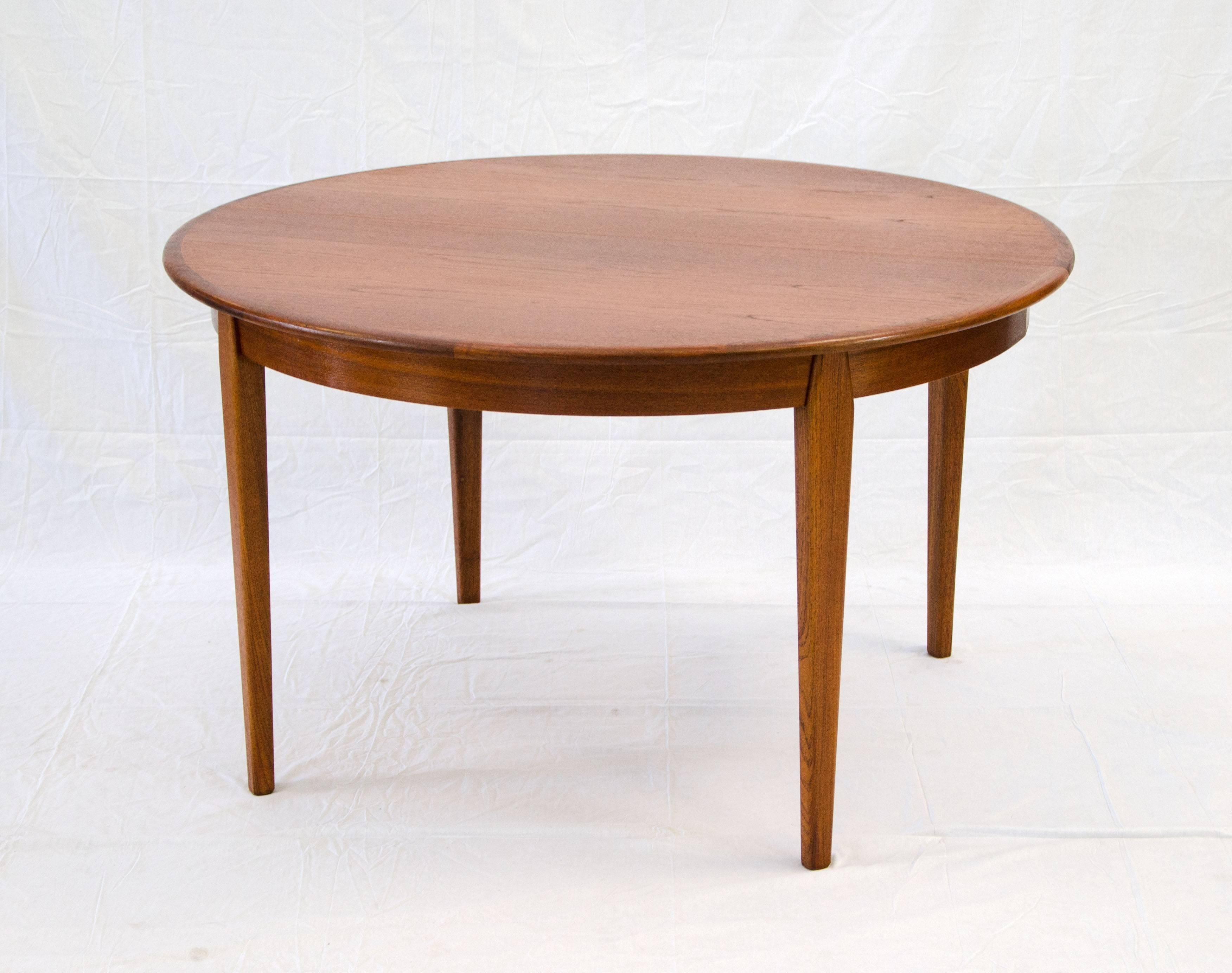 Beautiful circular Danish teak dining table with accent edge and three 23 1/2